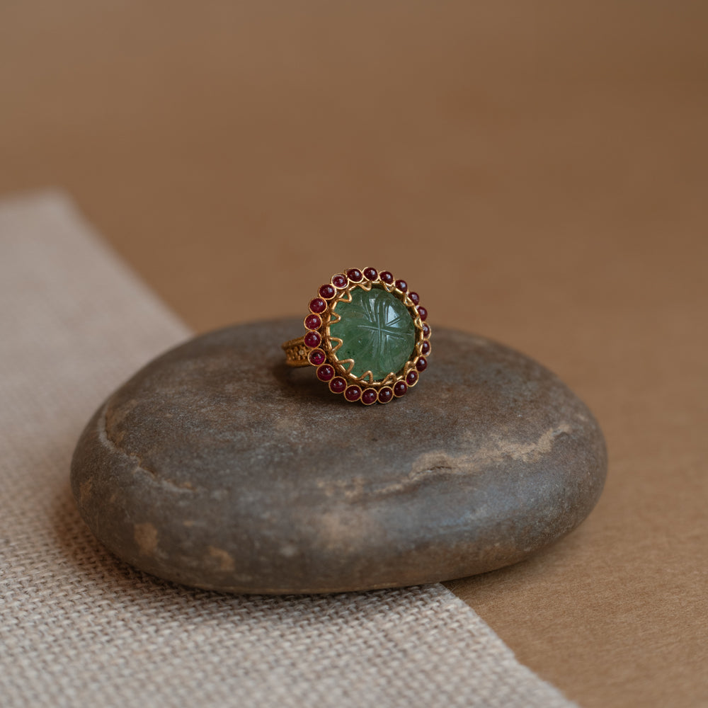 Temple collection ring with green Spinal and white Polki stones in traditional design.