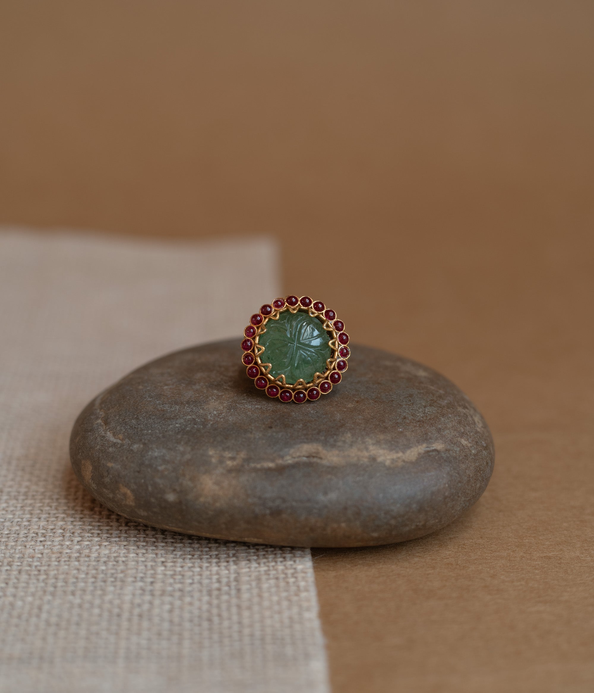 Temple collection ring with green Spinal and white Polki stones in traditional design.