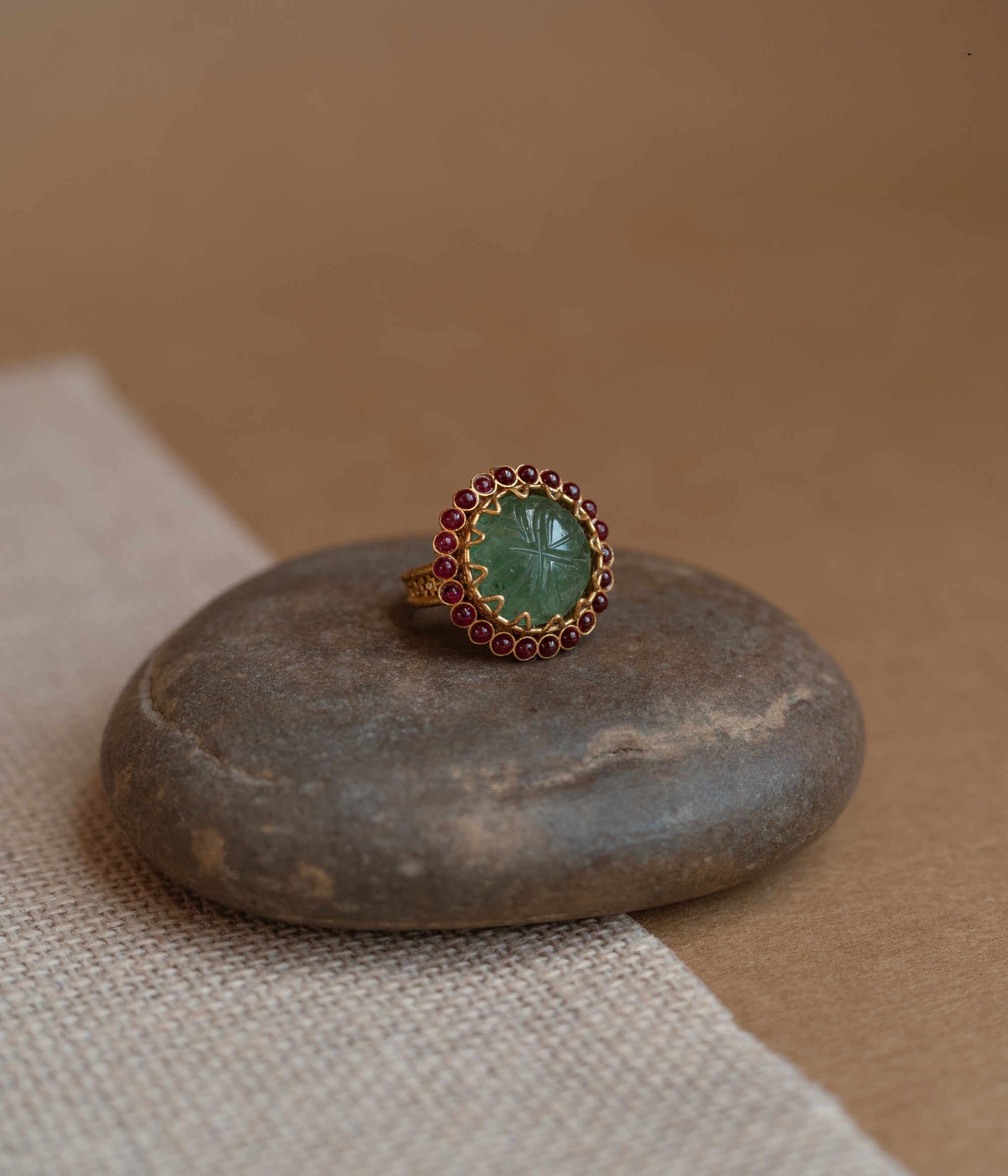 Temple collection ring with green Spinal and white Polki stones in traditional design.