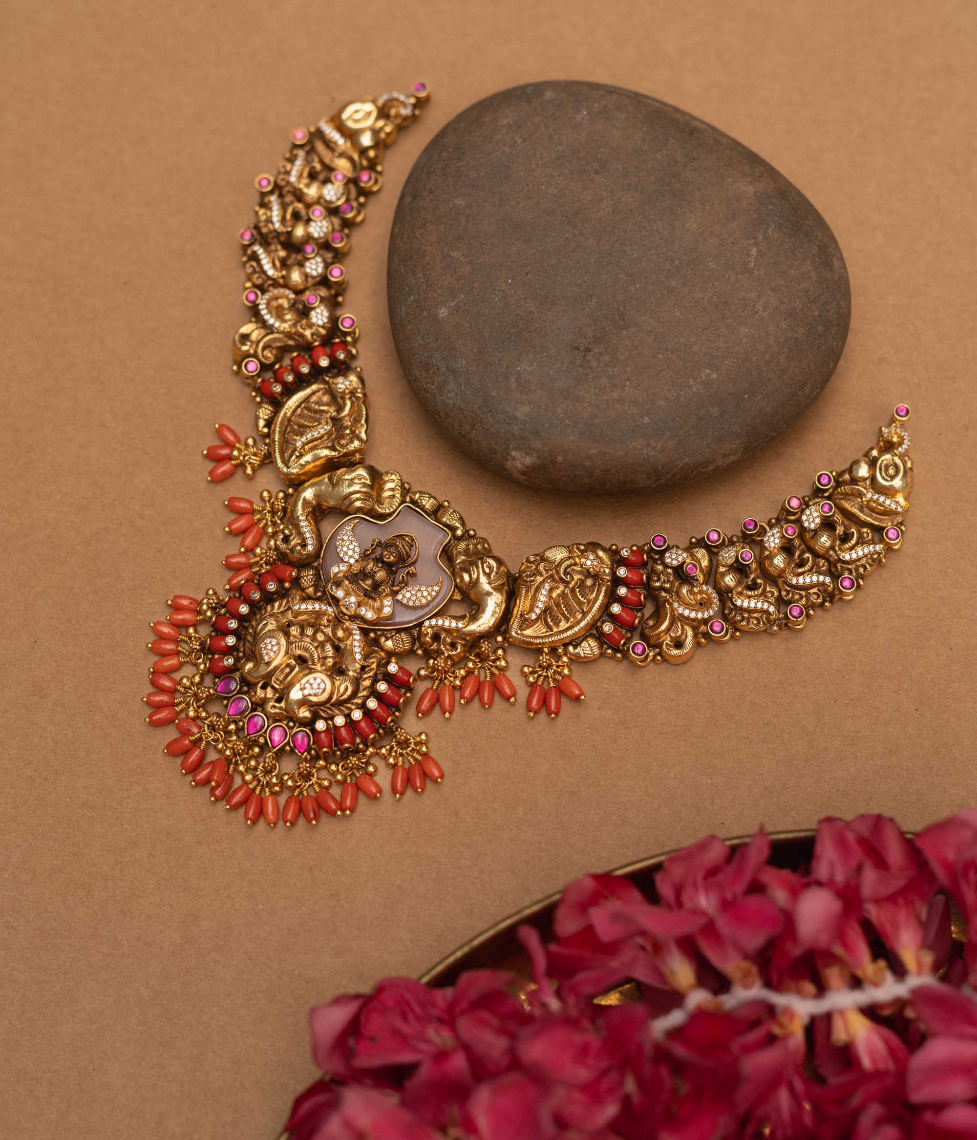 Antique gold-finished 92.5 sterling silver Nakshi necklace featuring intricately handcrafted mythical creatures and traditional motifs with vibrant gemstones, exuding timeless artistry and spiritual grace.