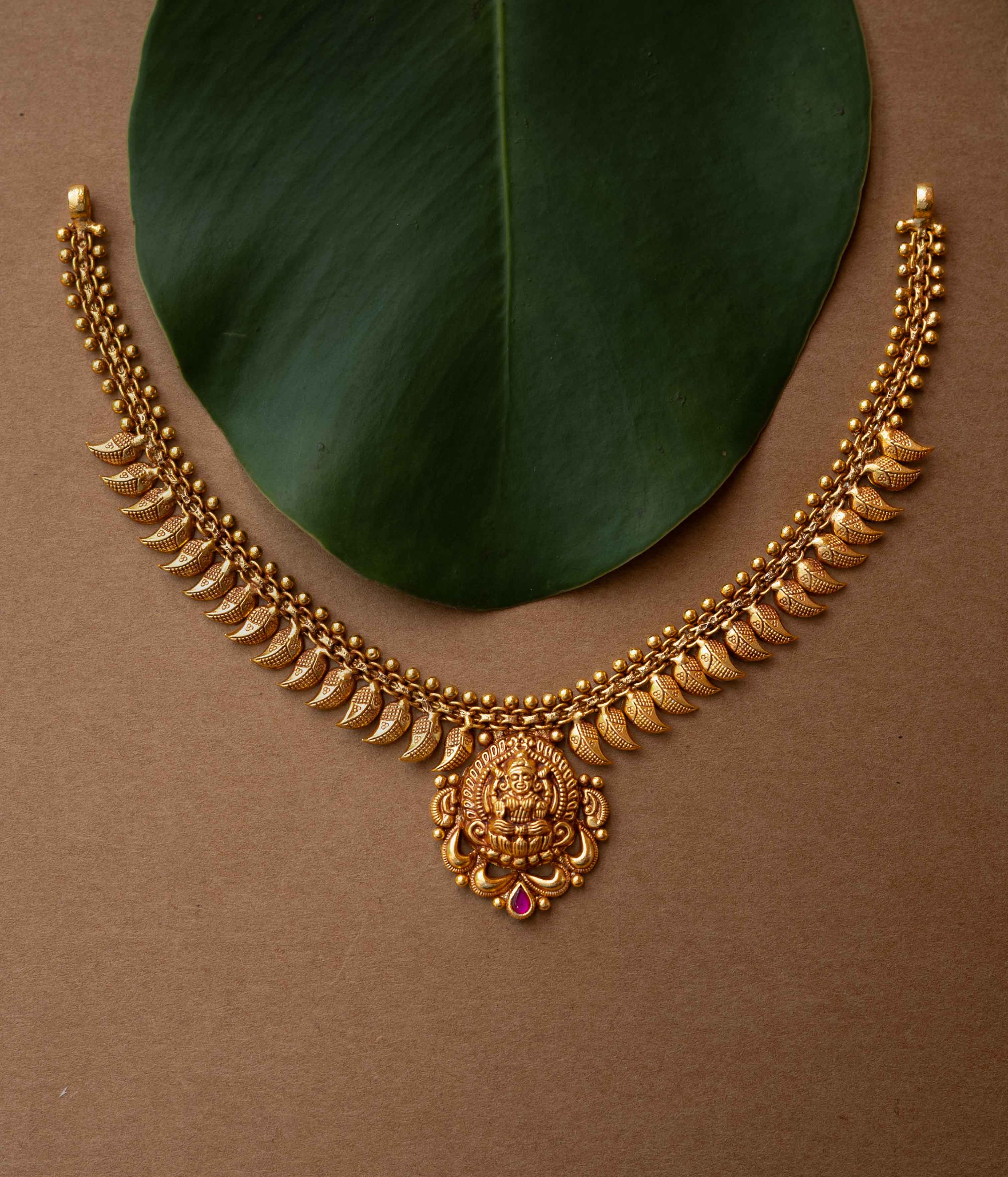 Antique gold necklace with Goddess Lakshmi pendant and crescent motifs from Temple Collection.