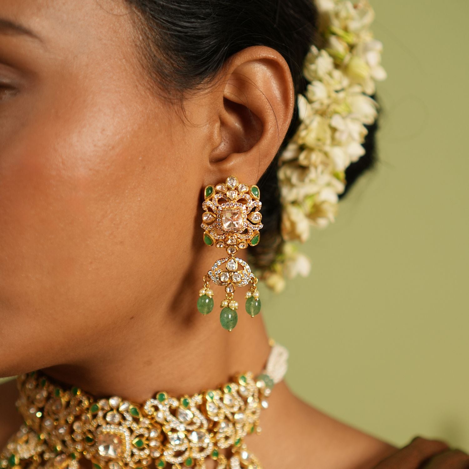 Graceful dangler earrings crafted in silver with a gold-plated finish, featuring intricate Polki stones, vibrant strawberry quartz, and sparkling CZ stones for a stunning and timeless design.