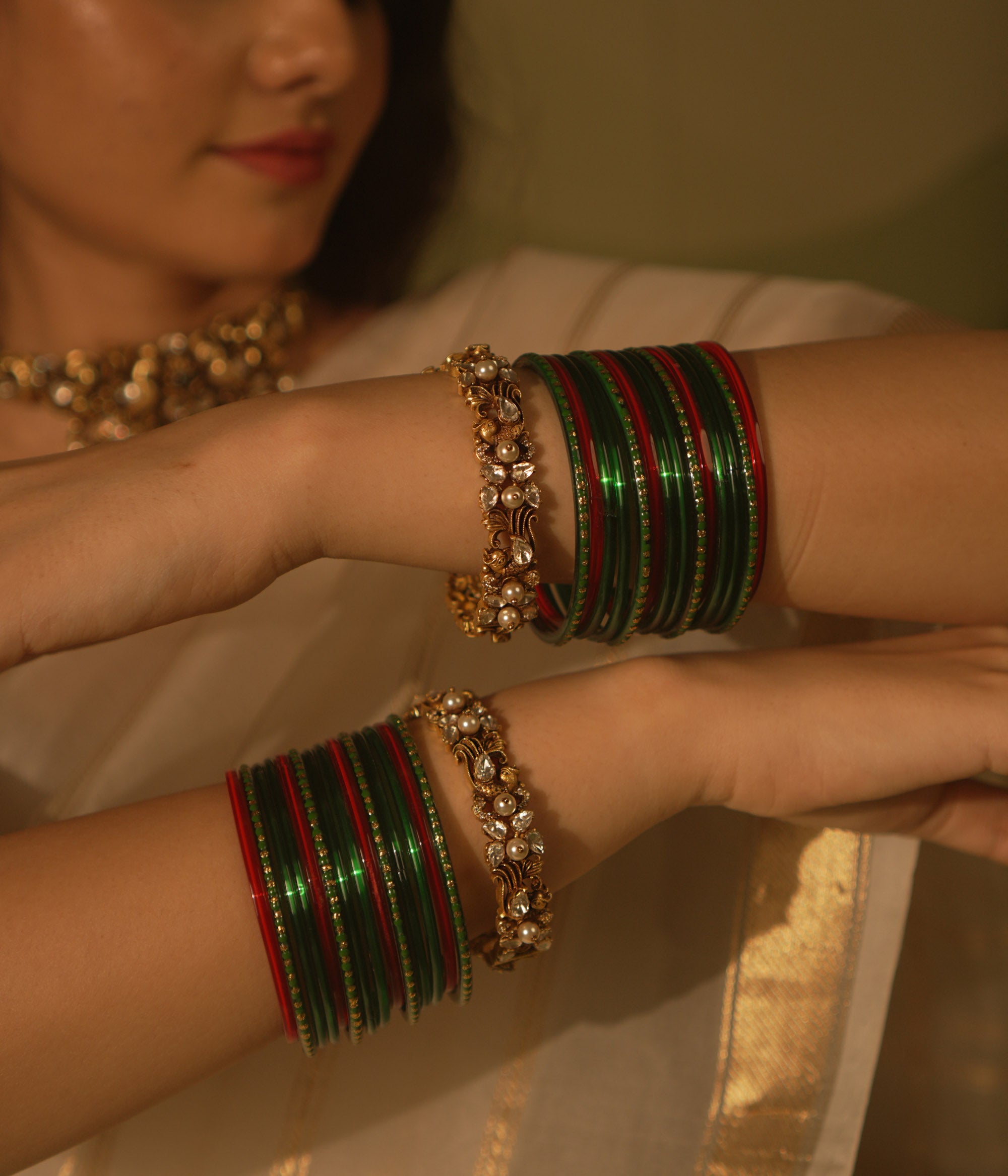 Golden temple bangle with peacock motif, Polki stones, and pearl detailing.