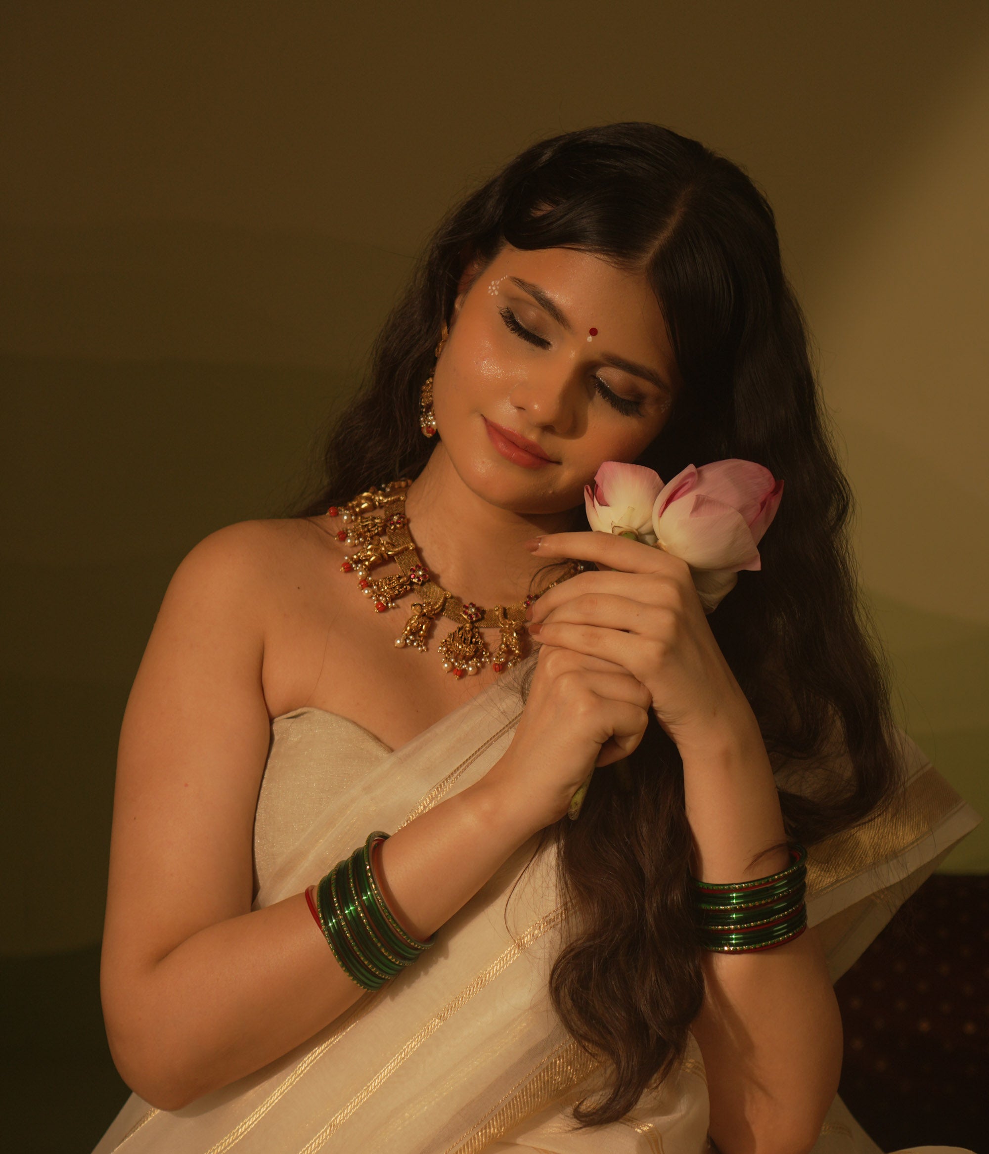 Temple collection Aamal Necklace featuring Goddess Lakshmi, elephant motifs, pink Kundan stones, pearls, and coral beads.