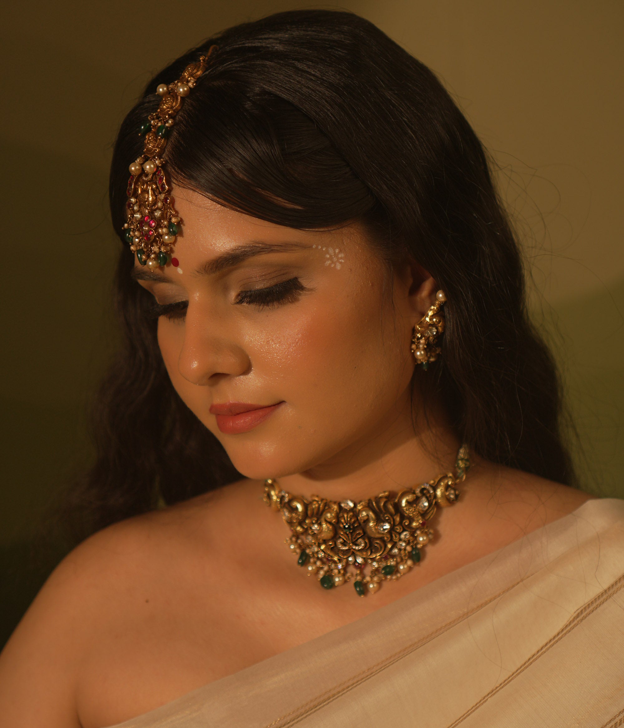 Temple collection choker with intricate peacock and floral carvings, adorned in Polki stones and pearls for ethnic elegance.