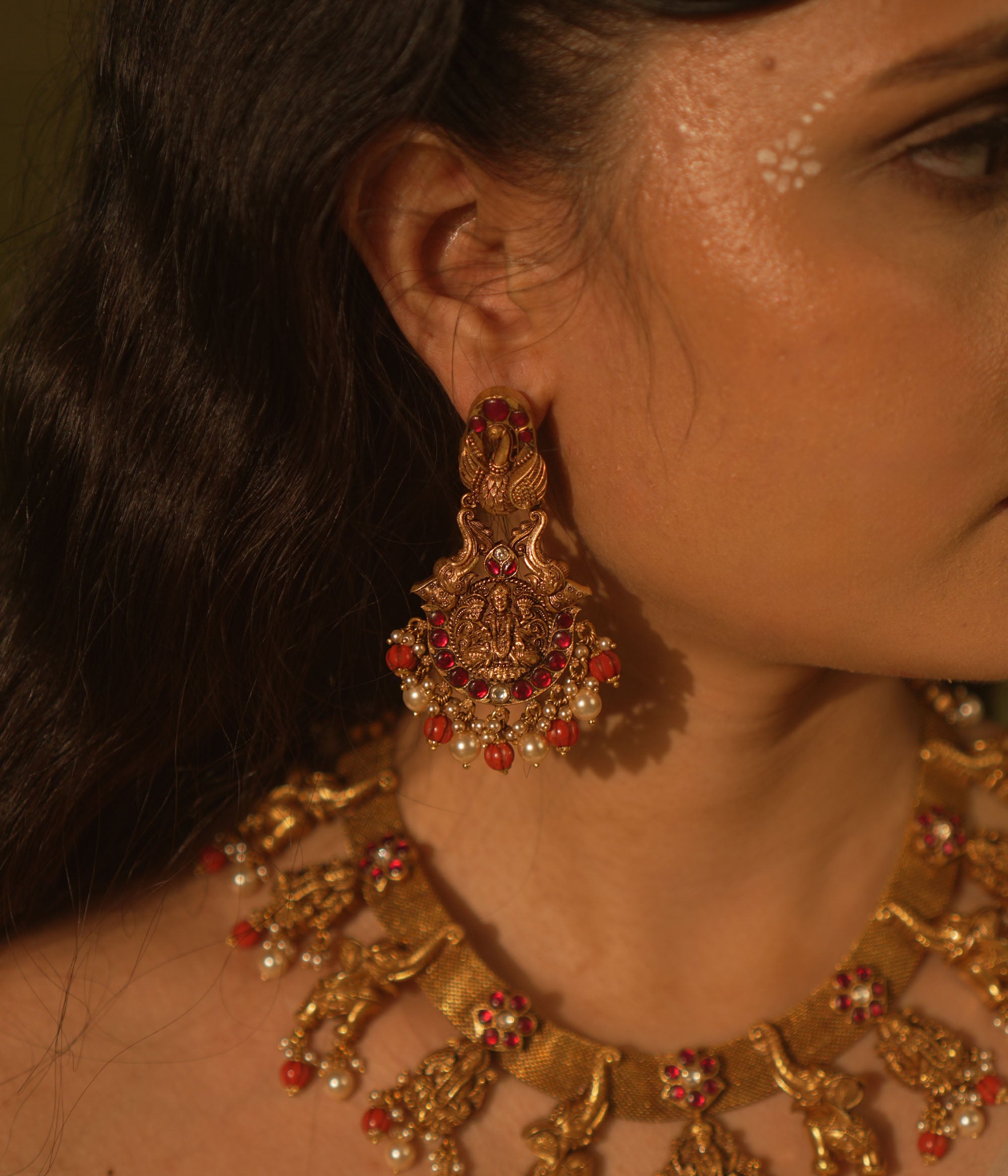 Temple collection Aamala Earrings with Goddess Lakshmi motif, elephants, pink Kundan stones, pearls, and coral beads.