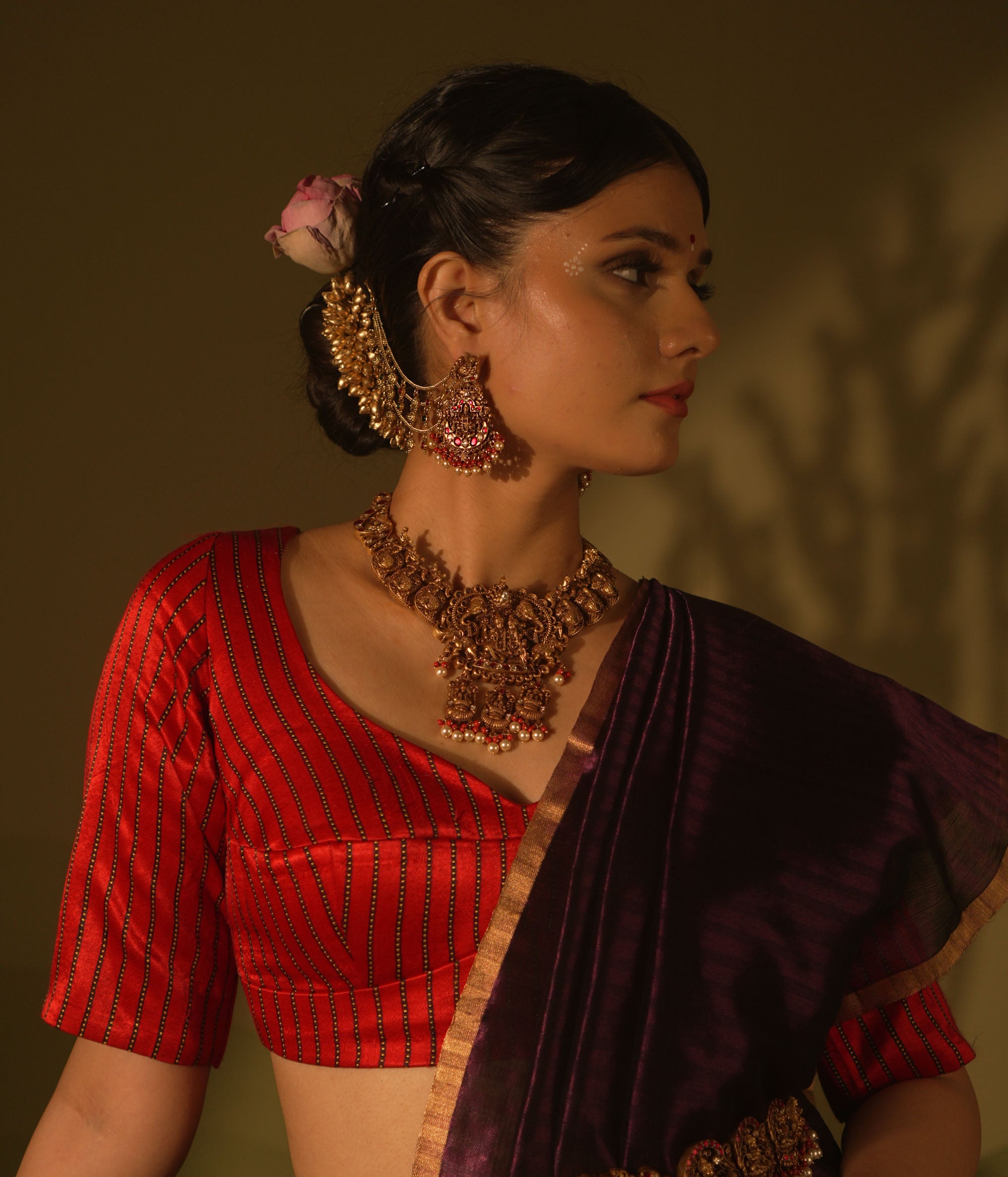 Ranjaki temple earrings with goddess motif, peacock stud, red-green Kundan, pearls, and cascading chains.