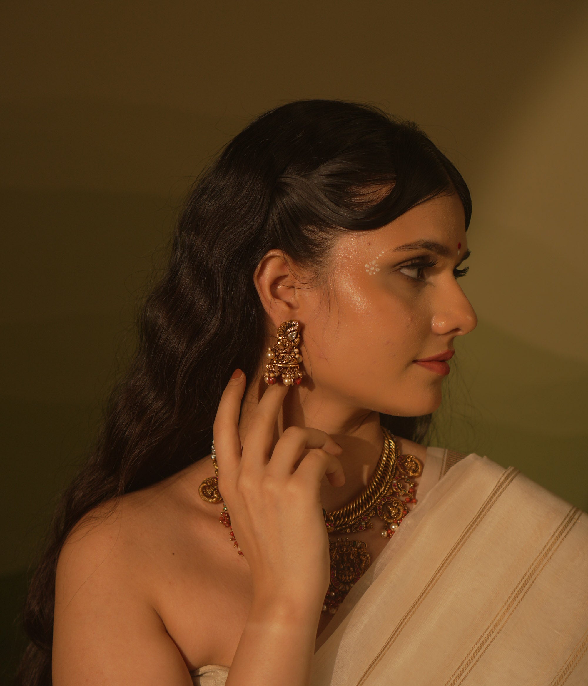 Temple collection Ujjaini Earrings with peacock motifs, coral stones, and Basra pearls, inspired by traditional Indian artistry.