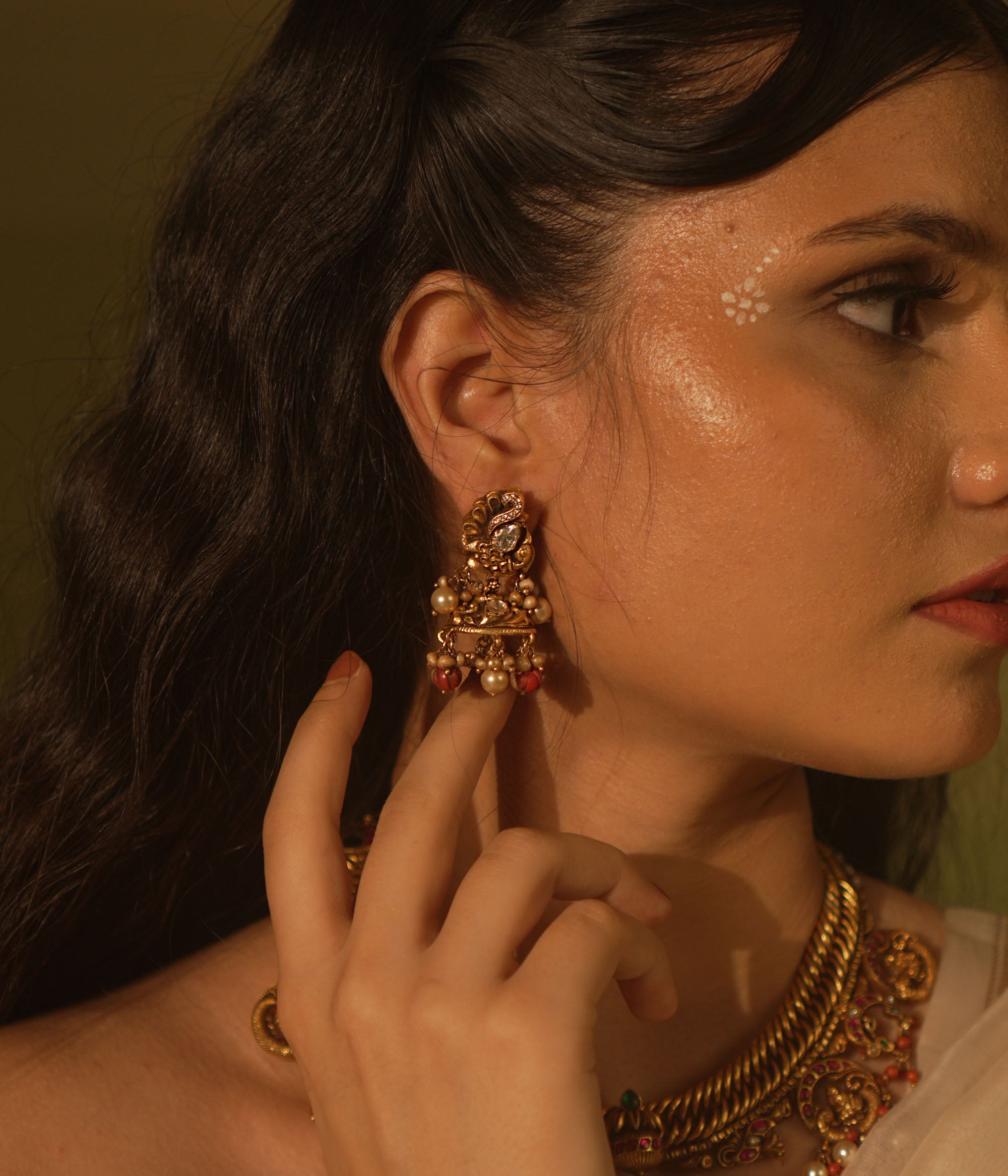 Temple collection Ujjaini Earrings with peacock motifs, coral stones, and Basra pearls, inspired by traditional Indian artistry.