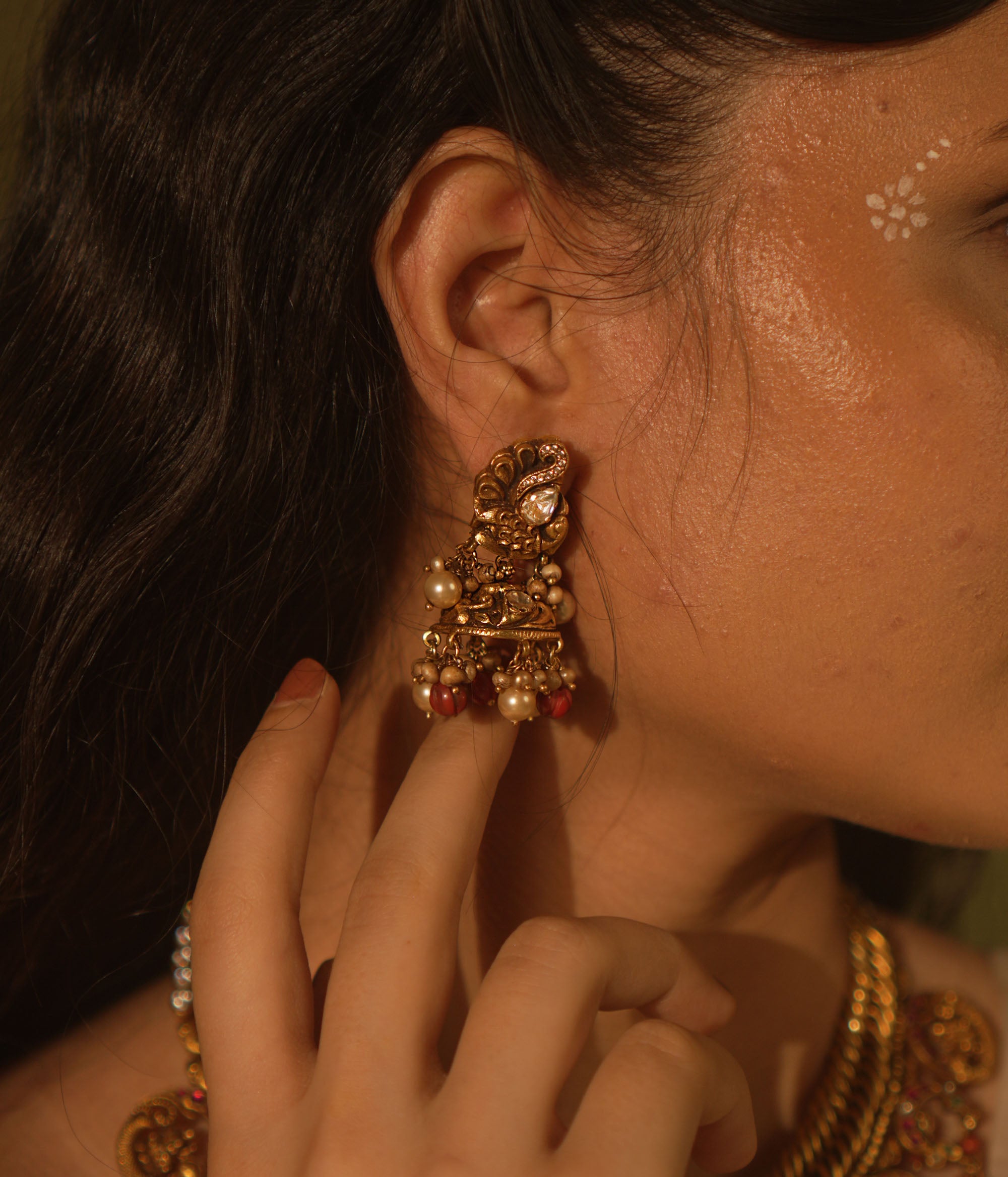 Temple collection Ujjaini Earrings with peacock motifs, coral stones, and Basra pearls, inspired by traditional Indian artistry.