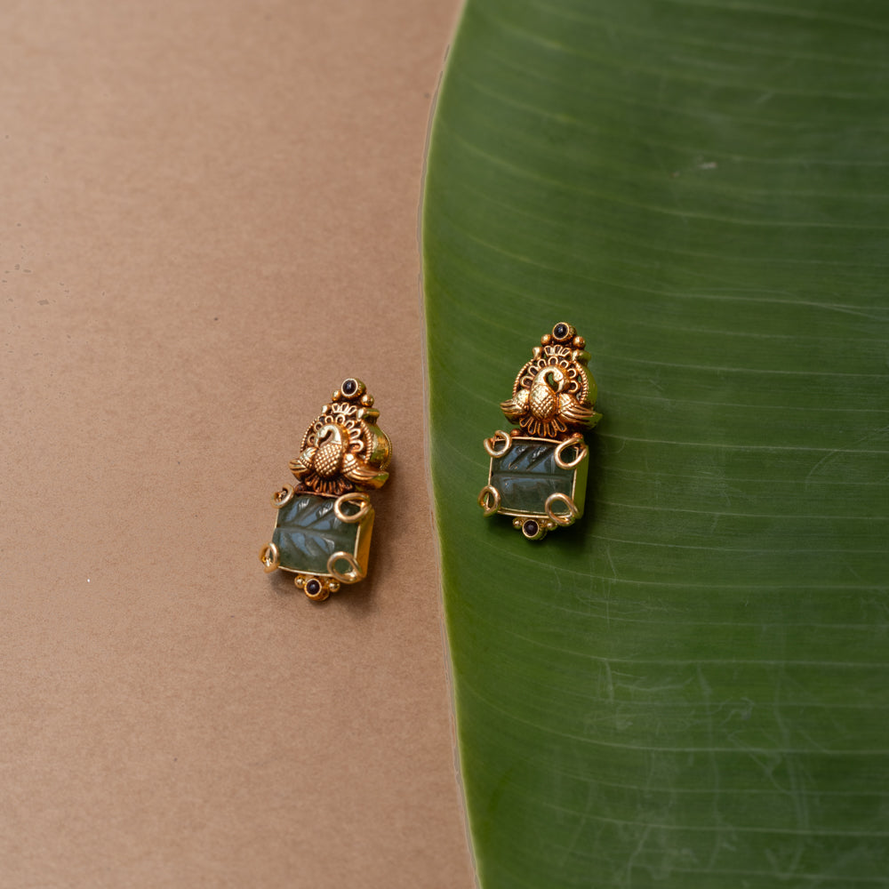Temple-style gold earrings with peacock design and green onyx stone, from the Temple Collection.