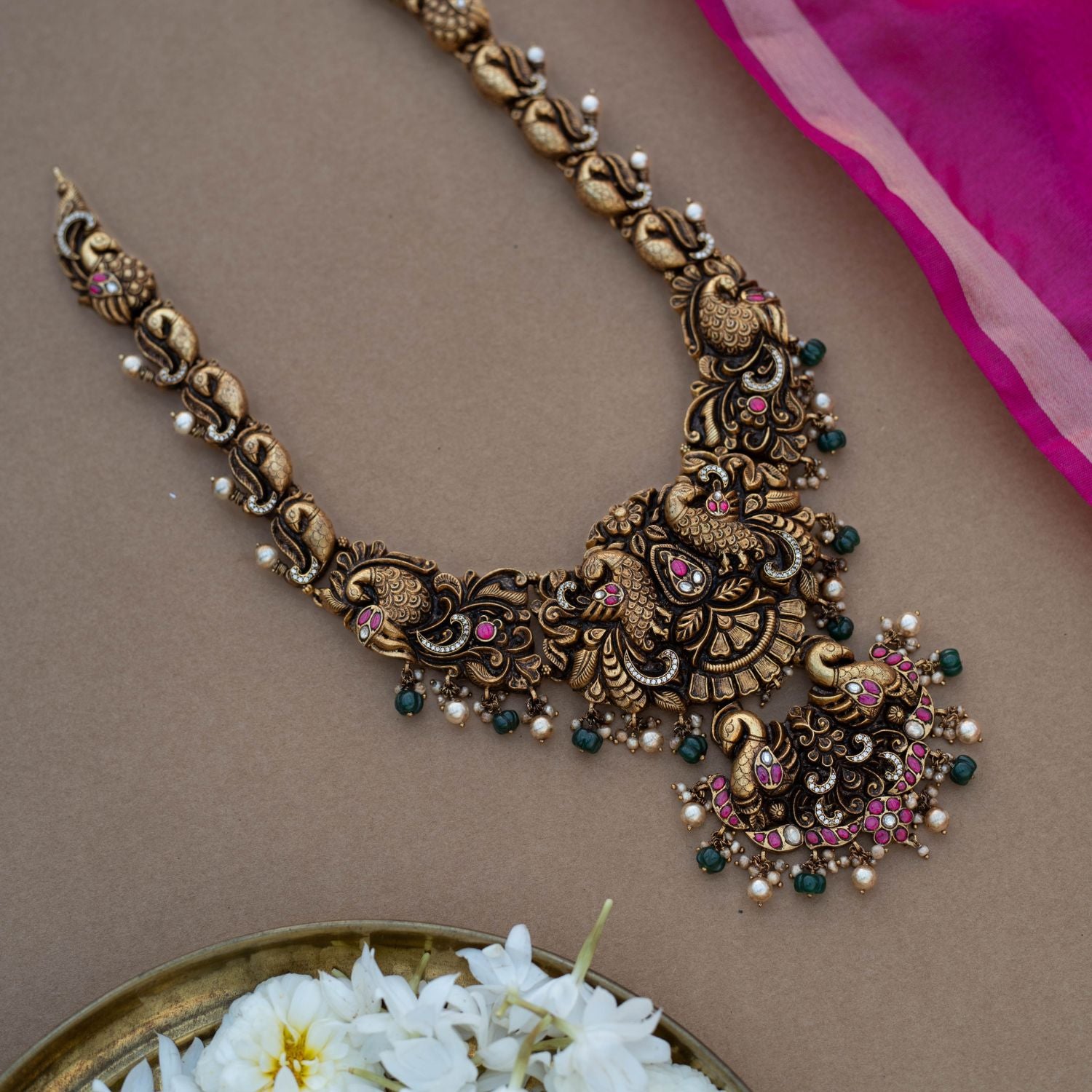 Traditional Rakni Necklace in 92.5 Sterling Silver and 22ct Gold Plated, featuring Kundan stones, green beads, and white pearls, with intricate peacock design and antique gold finish.