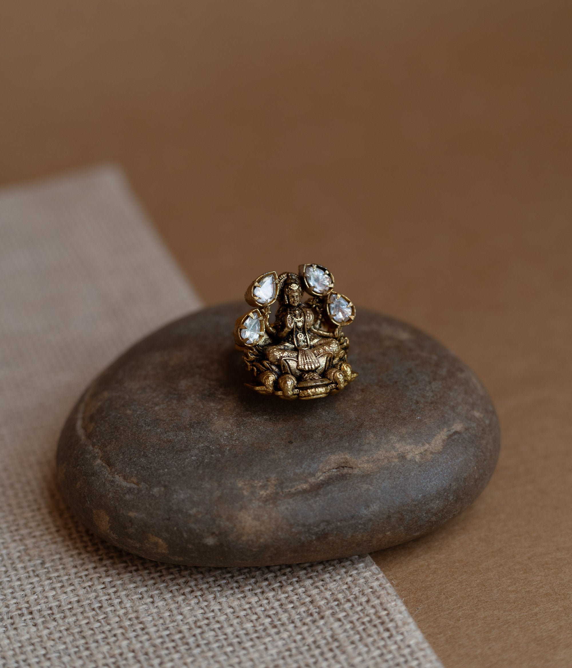 Temple collection ring with white Polki stone in circular motif, traditional and elegant design.