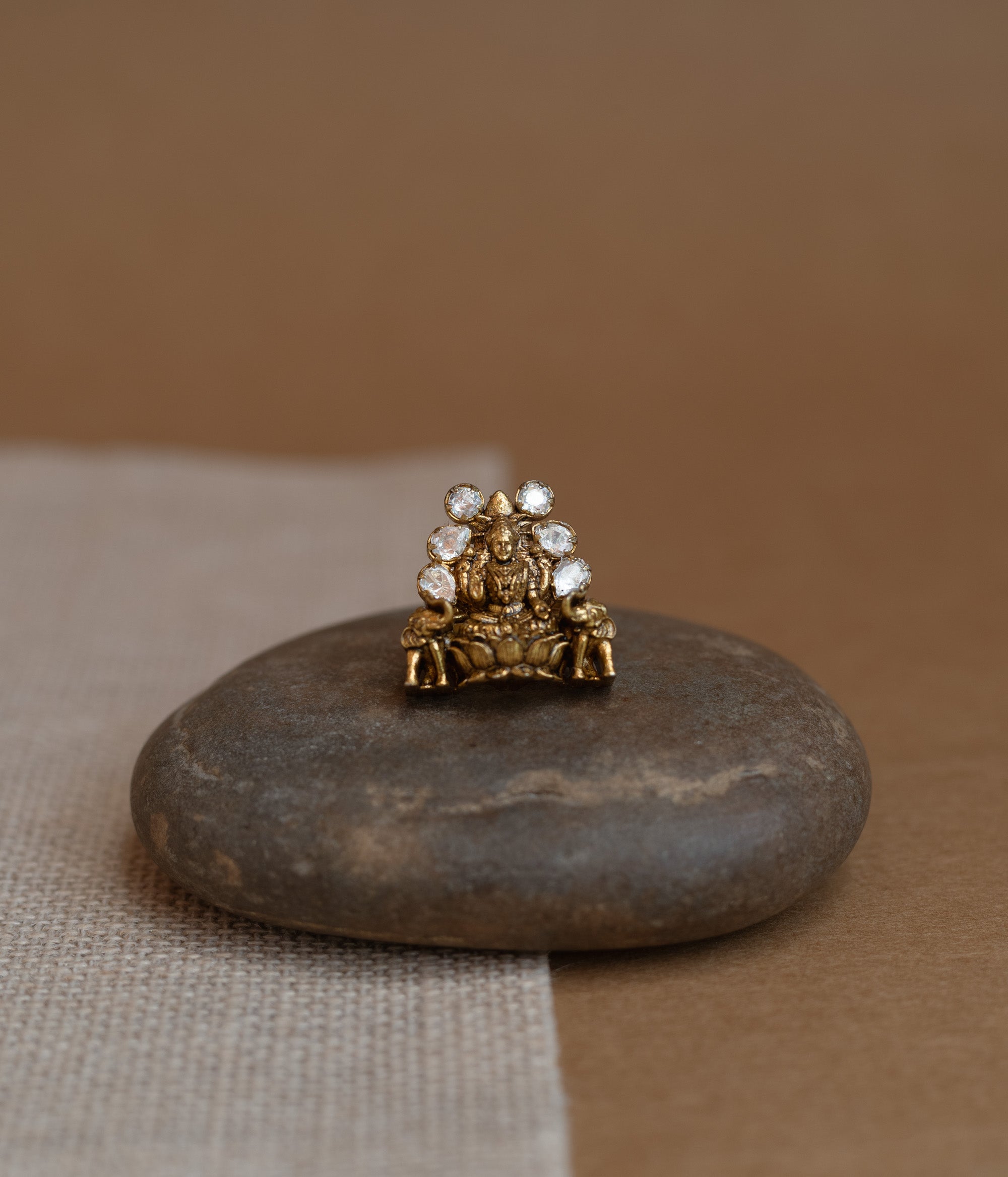 Temple ring with white Polki stone and intricate temple-inspired design for traditional occasions.