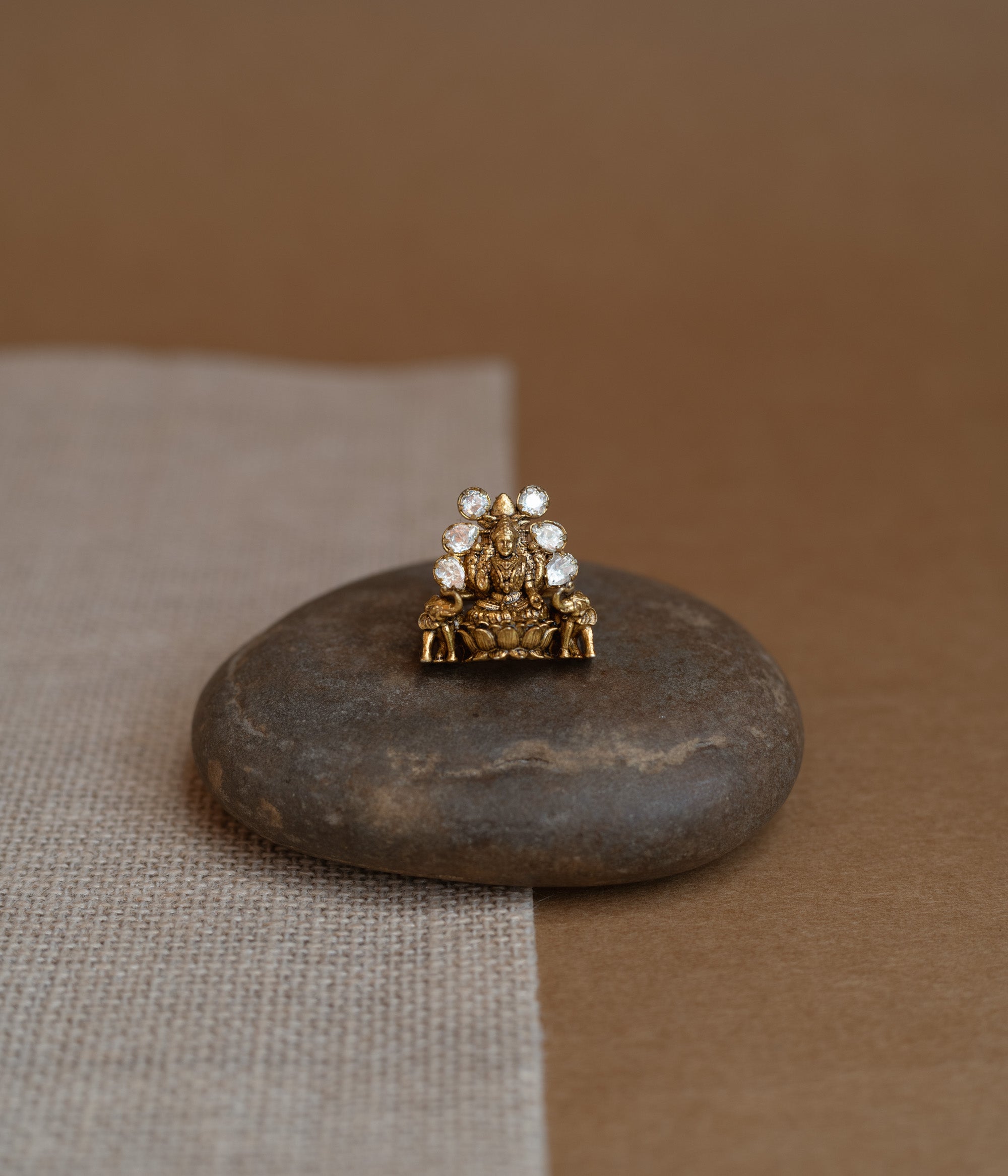 Temple ring with white Polki stone and intricate temple-inspired design for traditional occasions.