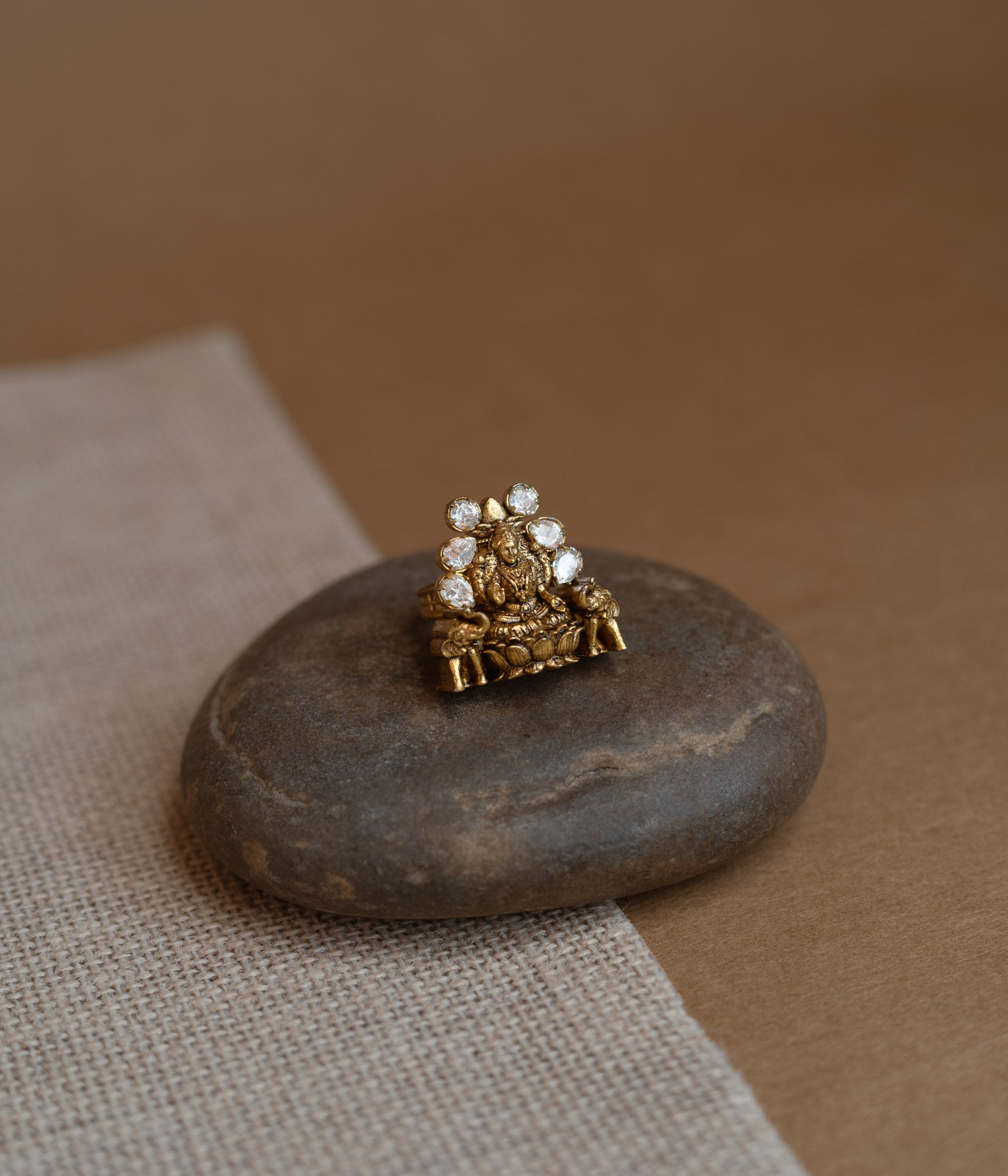 Temple ring with white Polki stone and intricate temple-inspired design for traditional occasions.