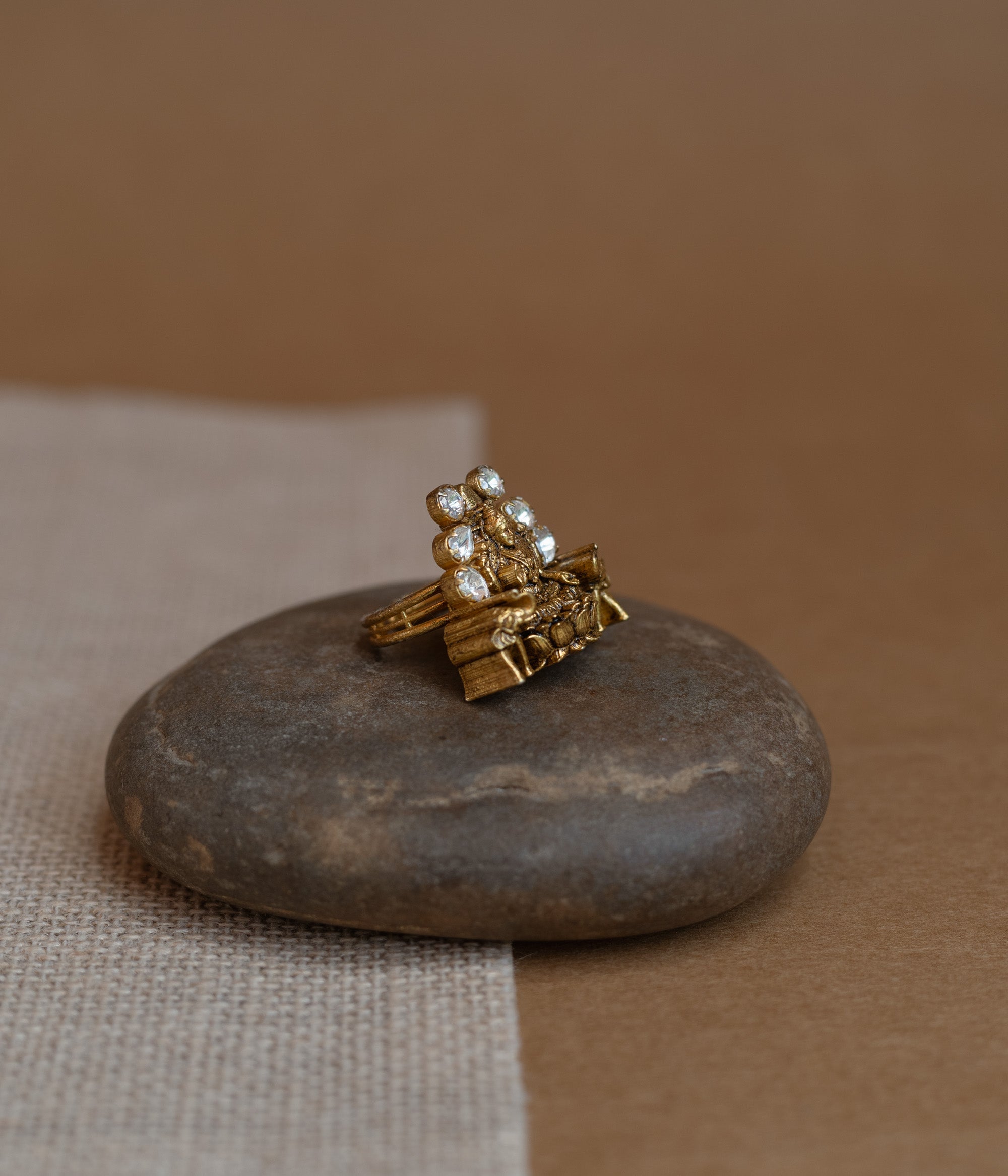 Temple ring with white Polki stone and intricate temple-inspired design for traditional occasions.