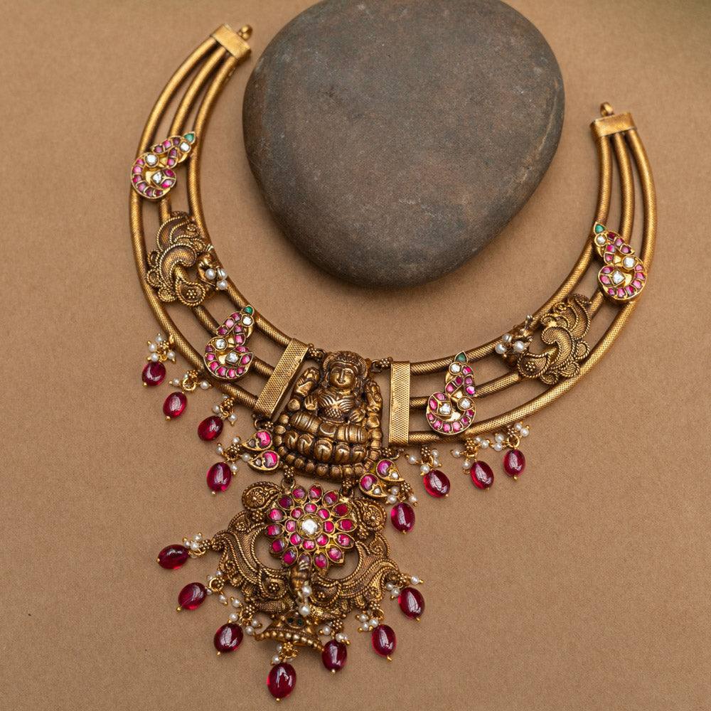 A majestic 92.5 sterling silver Meenakshi Temple Heritage Necklace, featuring a grand Lakshmi pendant, ruby red drops, and intricate meenakari paisley motifs, radiating divine elegance and royal charm for bridal and festive wear.
