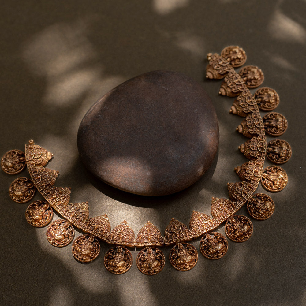 A striking 92.5 sterling silver necklace featuring intricately crafted coins depicting the Goddess (Devi) with an antique gold plating, blending traditional Indian artistry with spiritual significance, perfect for festive and cultural celebrations