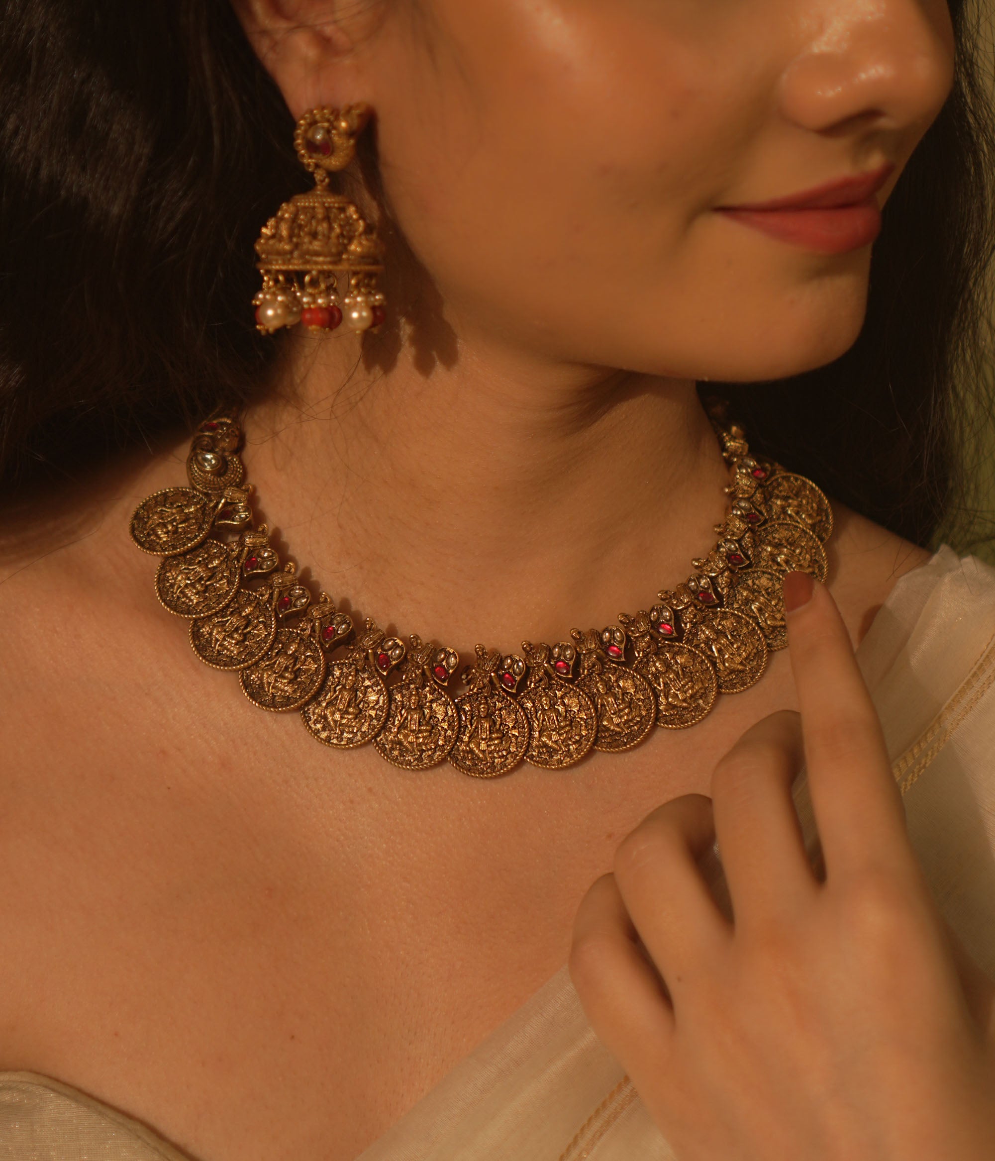 Temple collection Shyla Necklace featuring kasu coin motifs, pink Kundan stones, and divine Goddess Lakshmi-inspired design.