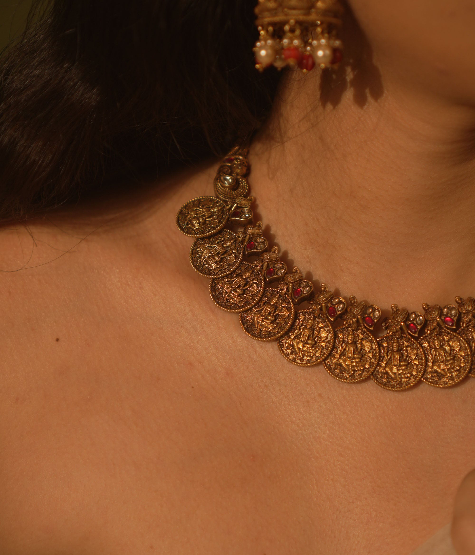 Temple collection Shyla Necklace featuring kasu coin motifs, pink Kundan stones, and divine Goddess Lakshmi-inspired design.