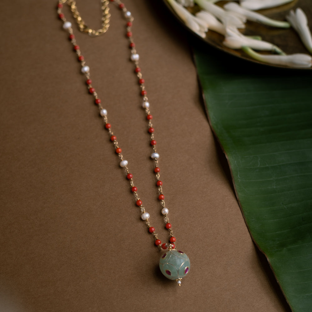 Hue collection chain with coral beads, pearls, and green stone sphere with red floral motifs.