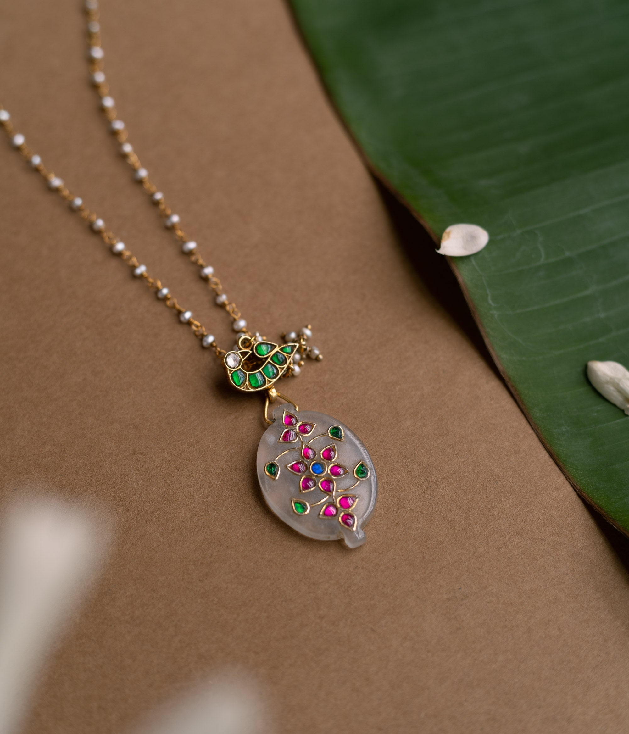 Hue Collection Lotus Glow Necklace with floral enamel pendant and delicate beaded chain.