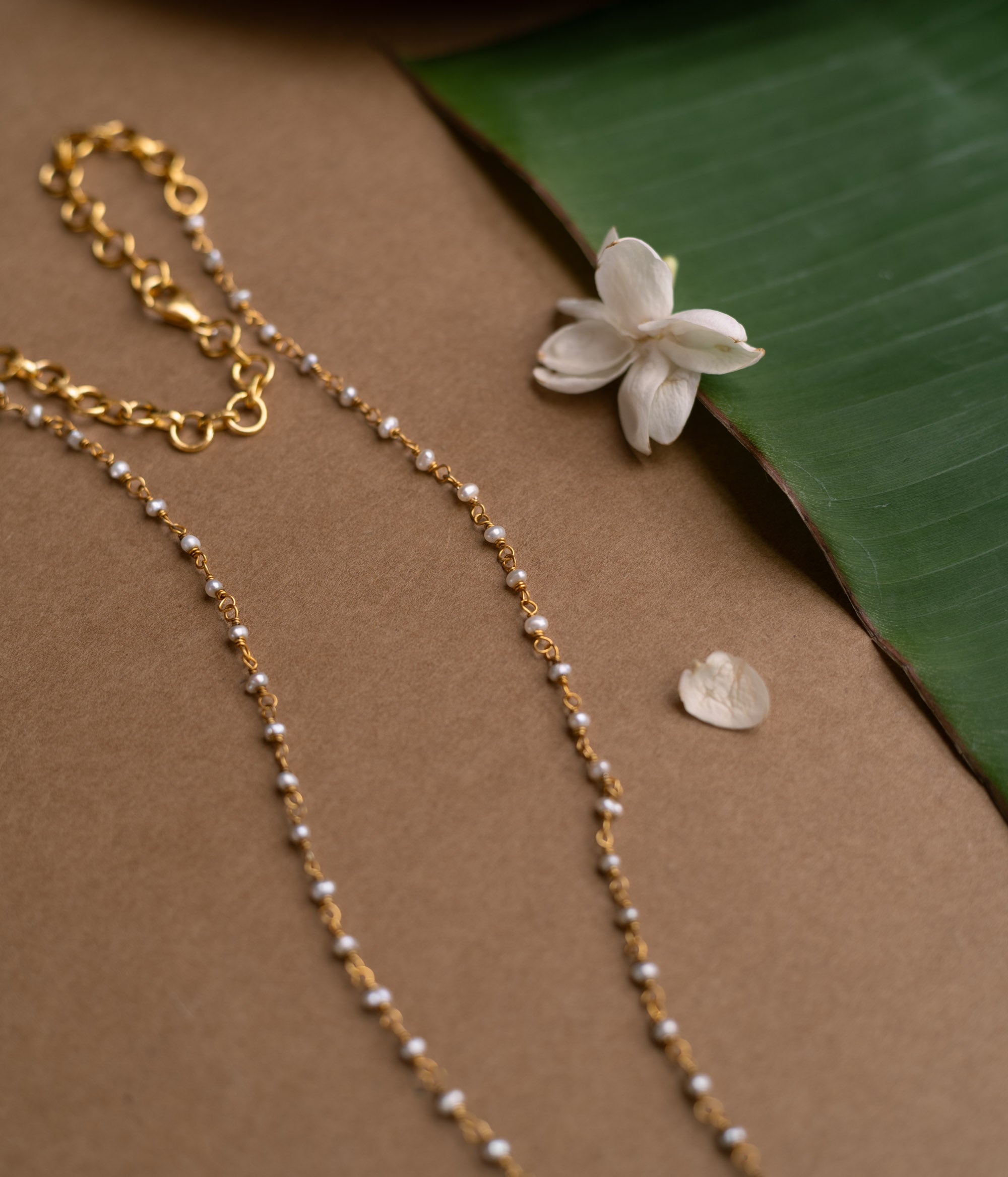 Hue Collection Lotus Glow Necklace with floral enamel pendant and delicate beaded chain.