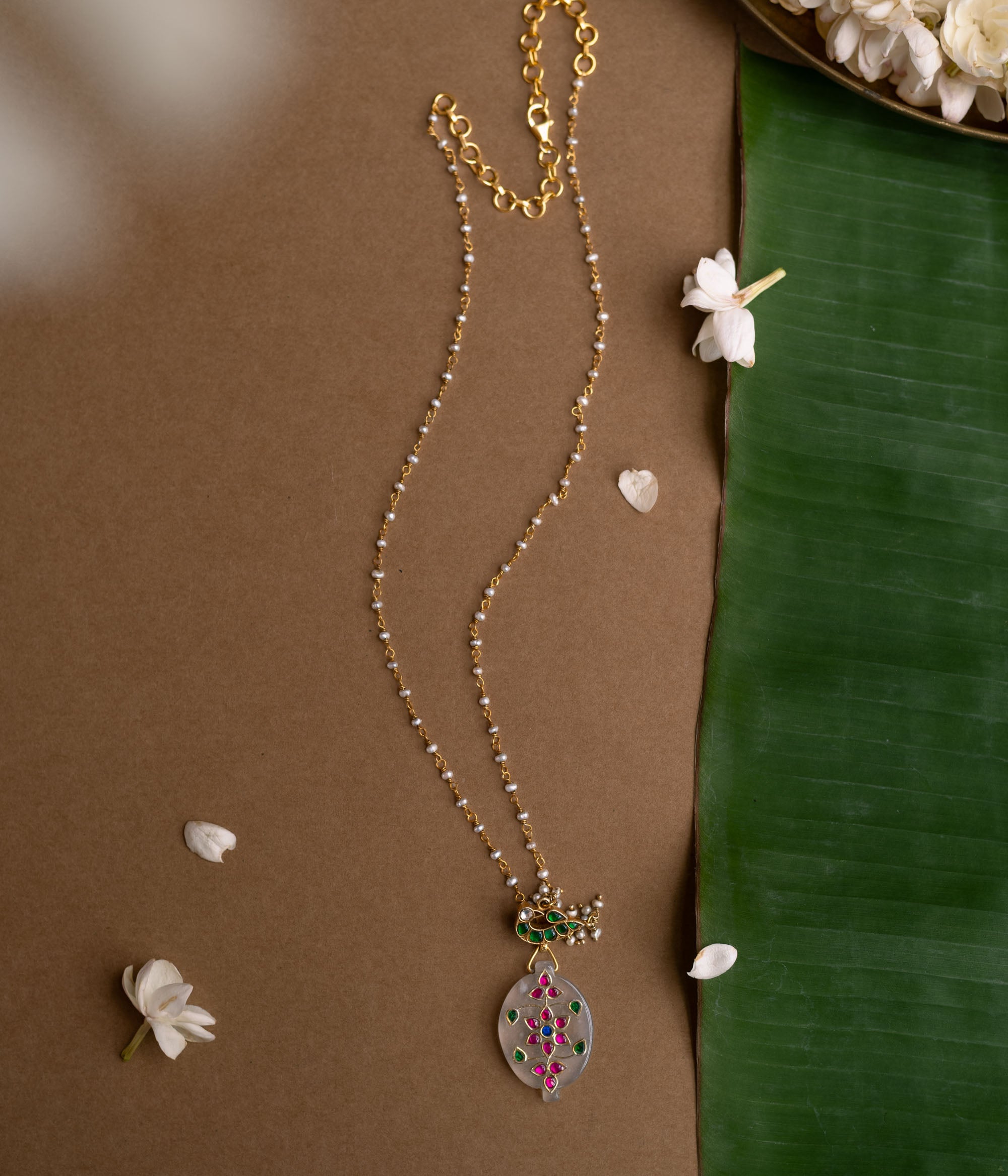 Hue Collection Lotus Glow Necklace with floral enamel pendant and delicate beaded chain.