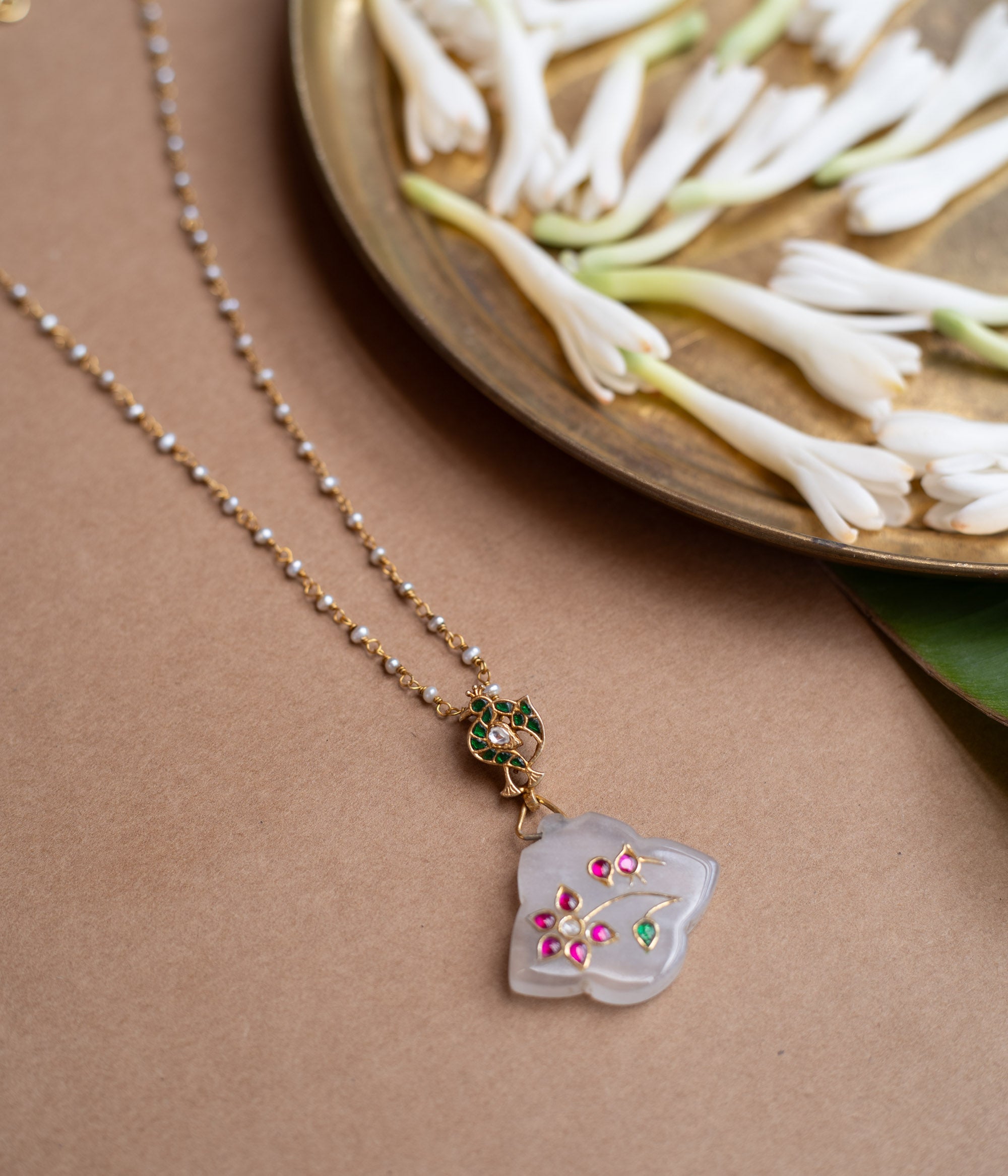 Hue collection crystal petal chain with pearls, pink stones, and green stone floral motif pendant.
