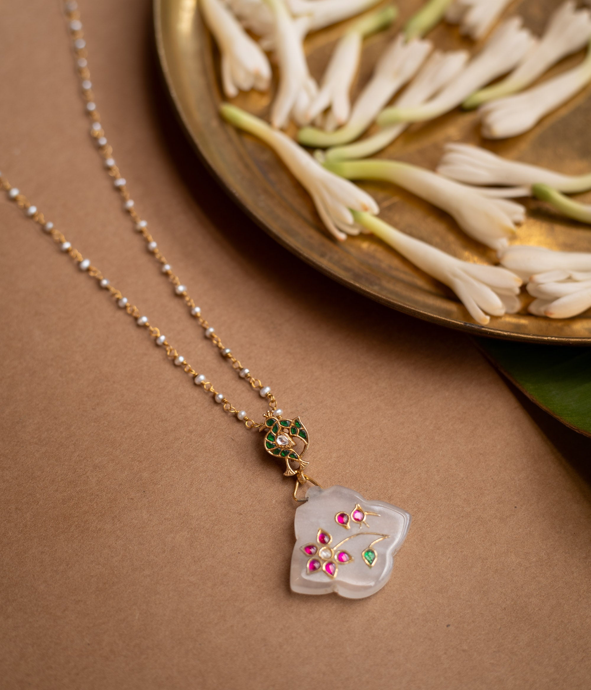 Hue collection crystal petal chain with pearls, pink stones, and green stone floral motif pendant.