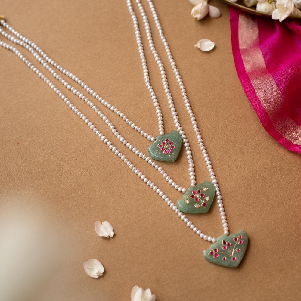 Hue collection pearl necklace with green stone pendants featuring pink floral motifs, elegant ethnic jewelry.