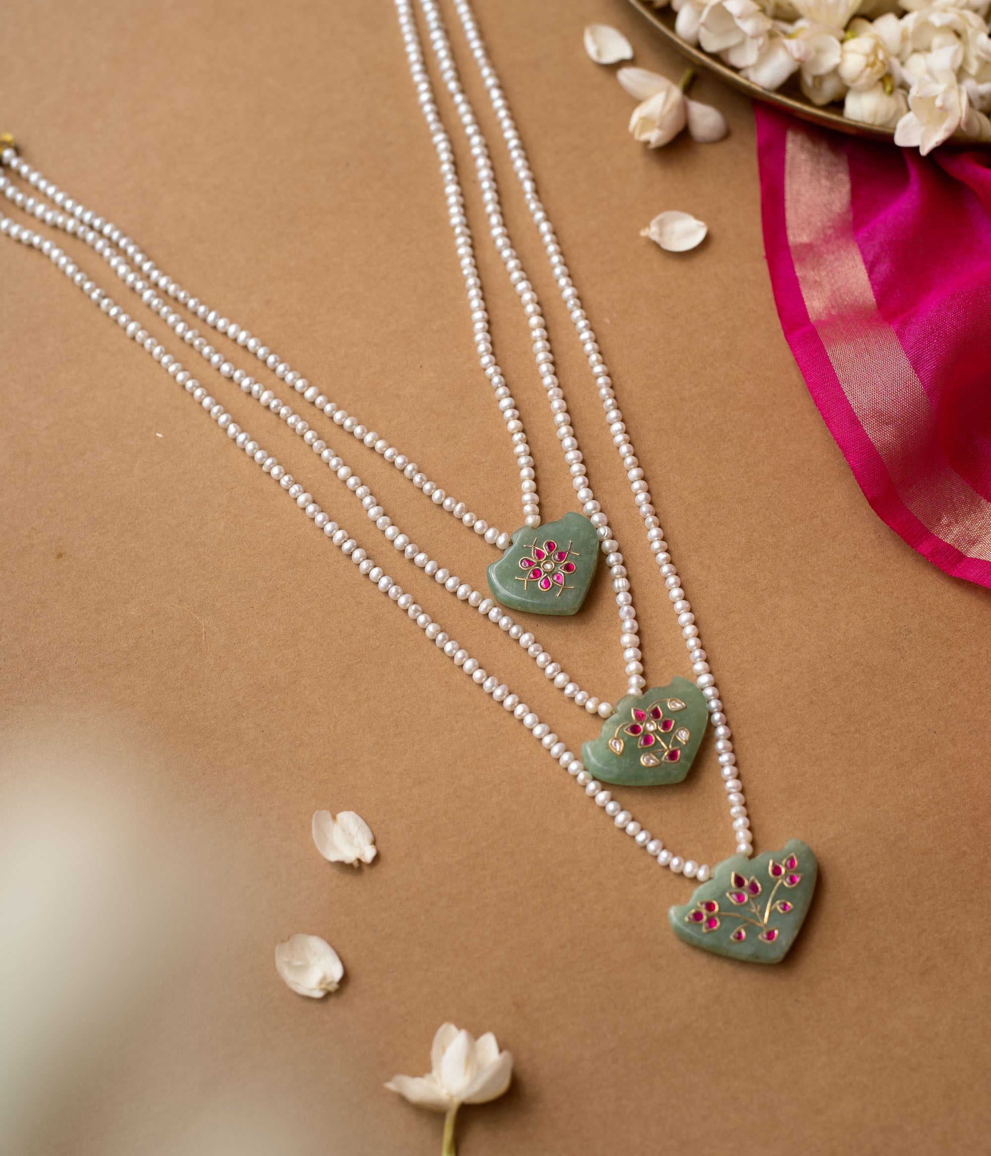 Hue collection pearl necklace with green stone pendants featuring pink floral motifs, elegant ethnic jewelry.