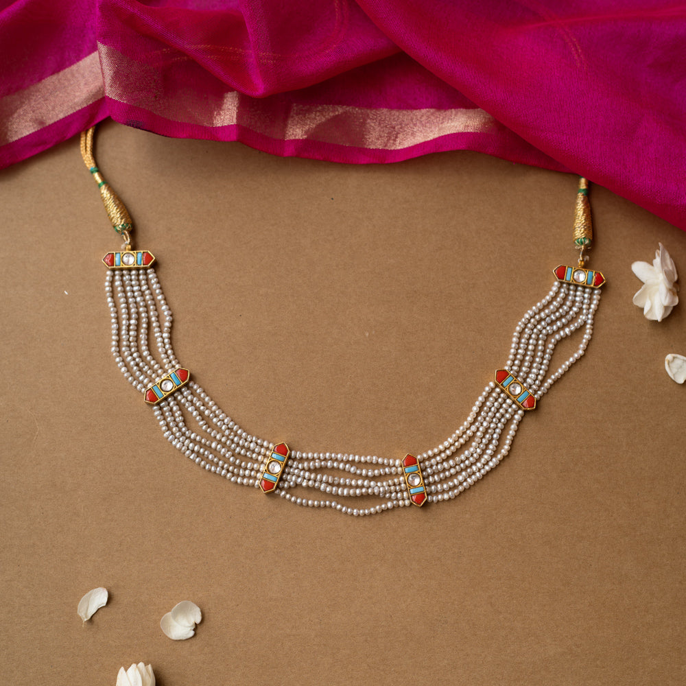 Multi-strand pearl necklace with colorful enamel connectors from Hue Collection, blending tradition and vibrant style.