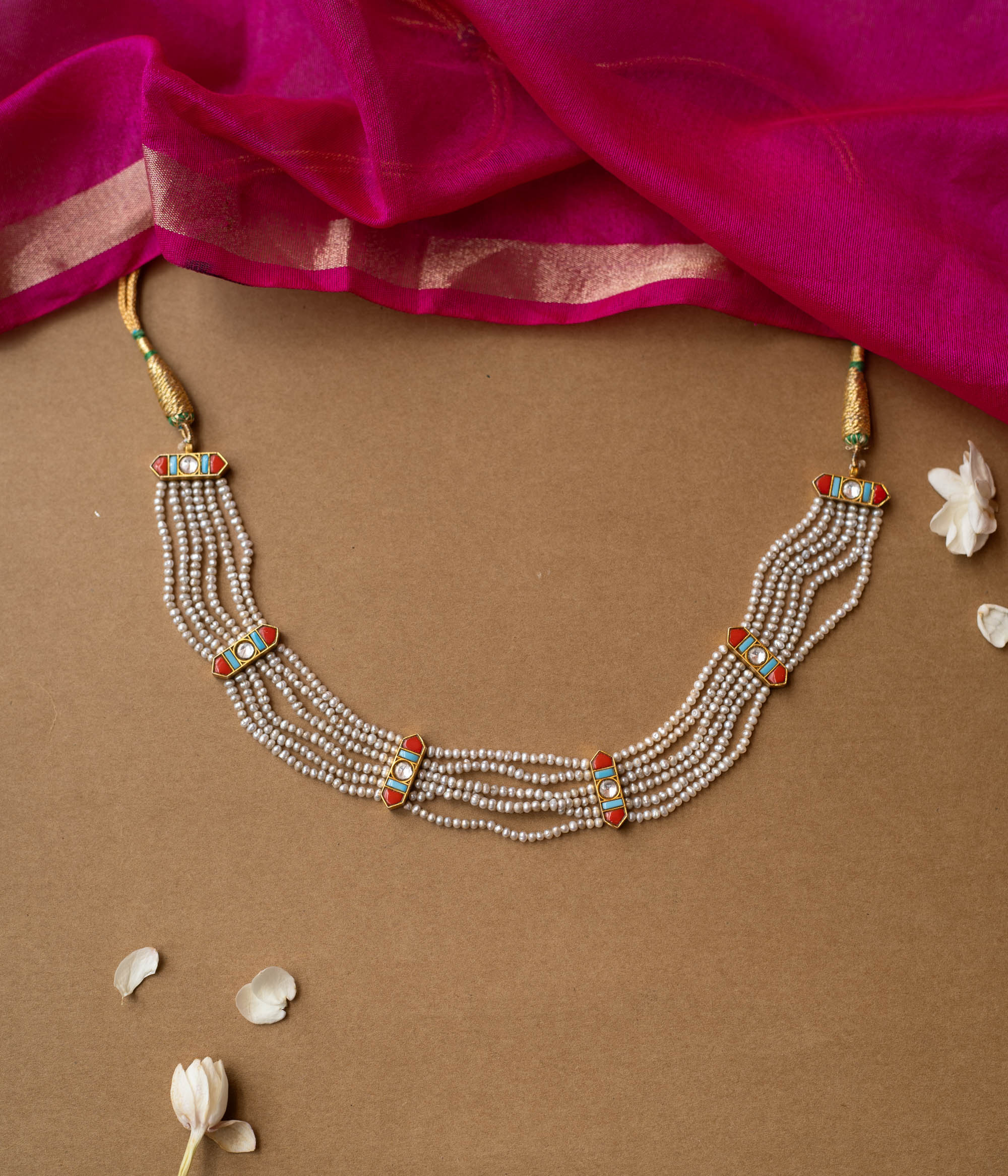 Multi-strand pearl necklace with colorful enamel connectors from Hue Collection, blending tradition and vibrant style.