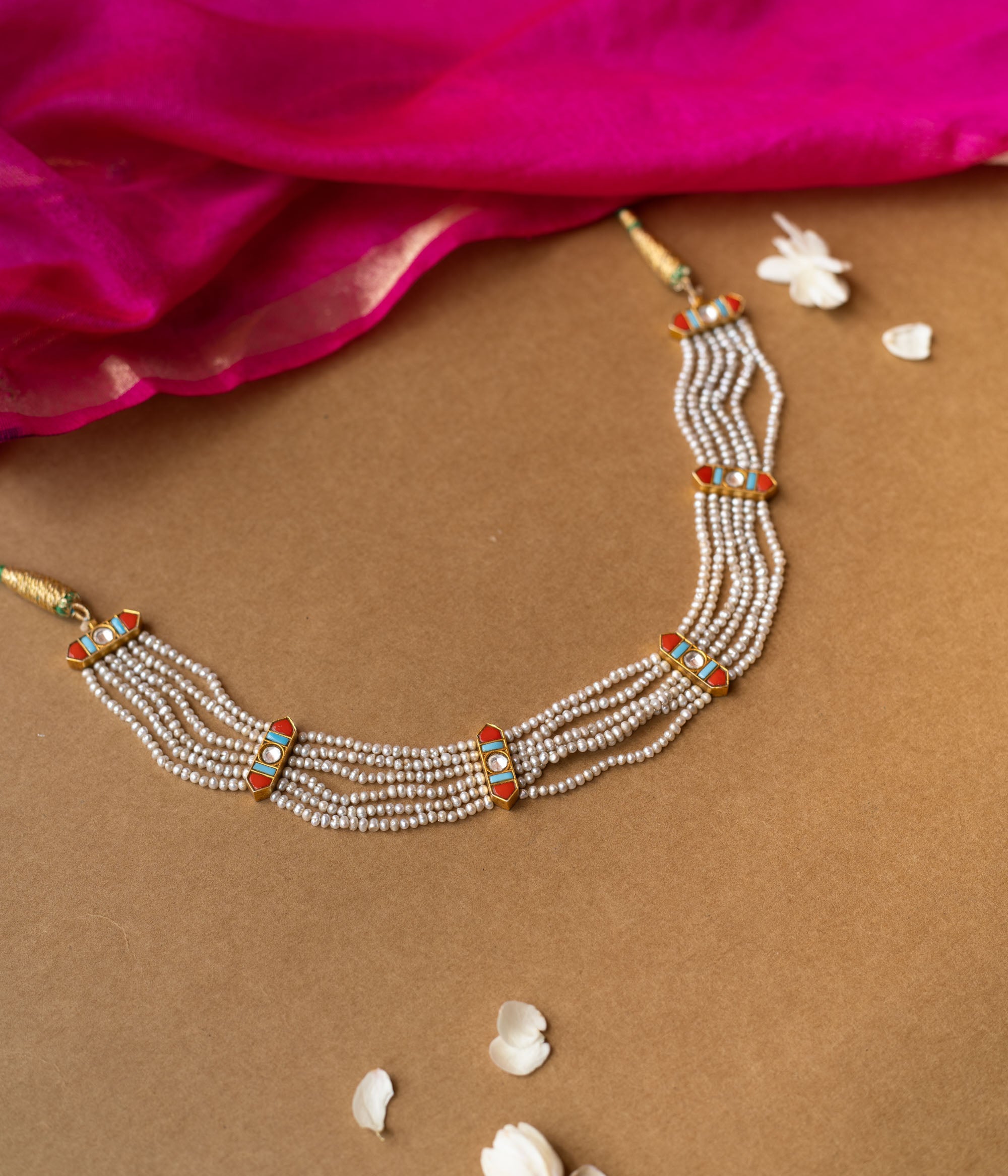 Multi-strand pearl necklace with colorful enamel connectors from Hue Collection, blending tradition and vibrant style.