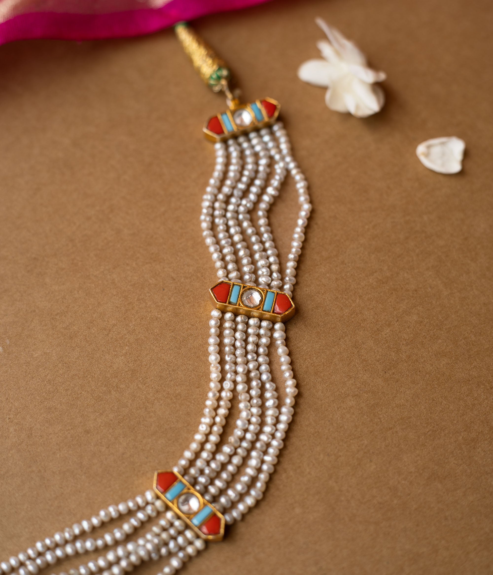 Multi-strand pearl necklace with colorful enamel connectors from Hue Collection, blending tradition and vibrant style.