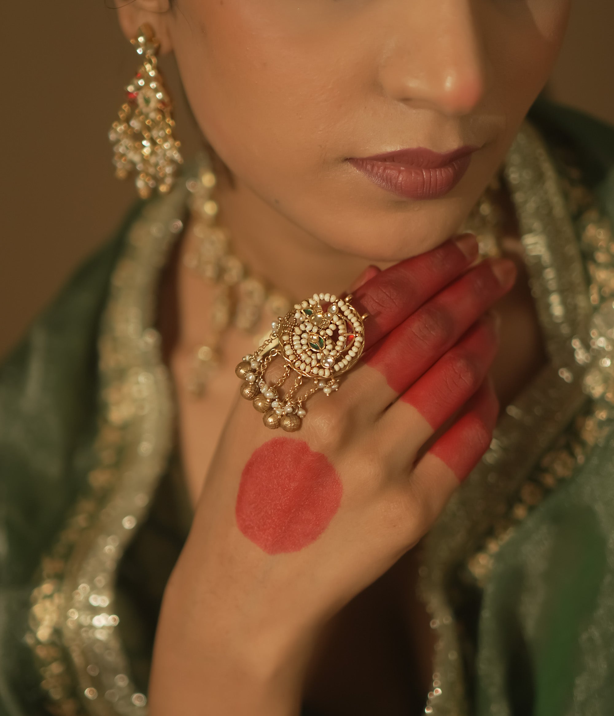 Gold ring with a swirl design, pearls, and small gems.