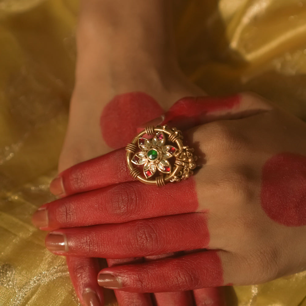 Gold-plated silver ring with a mandala design and green, red, and clear Kundan stones.