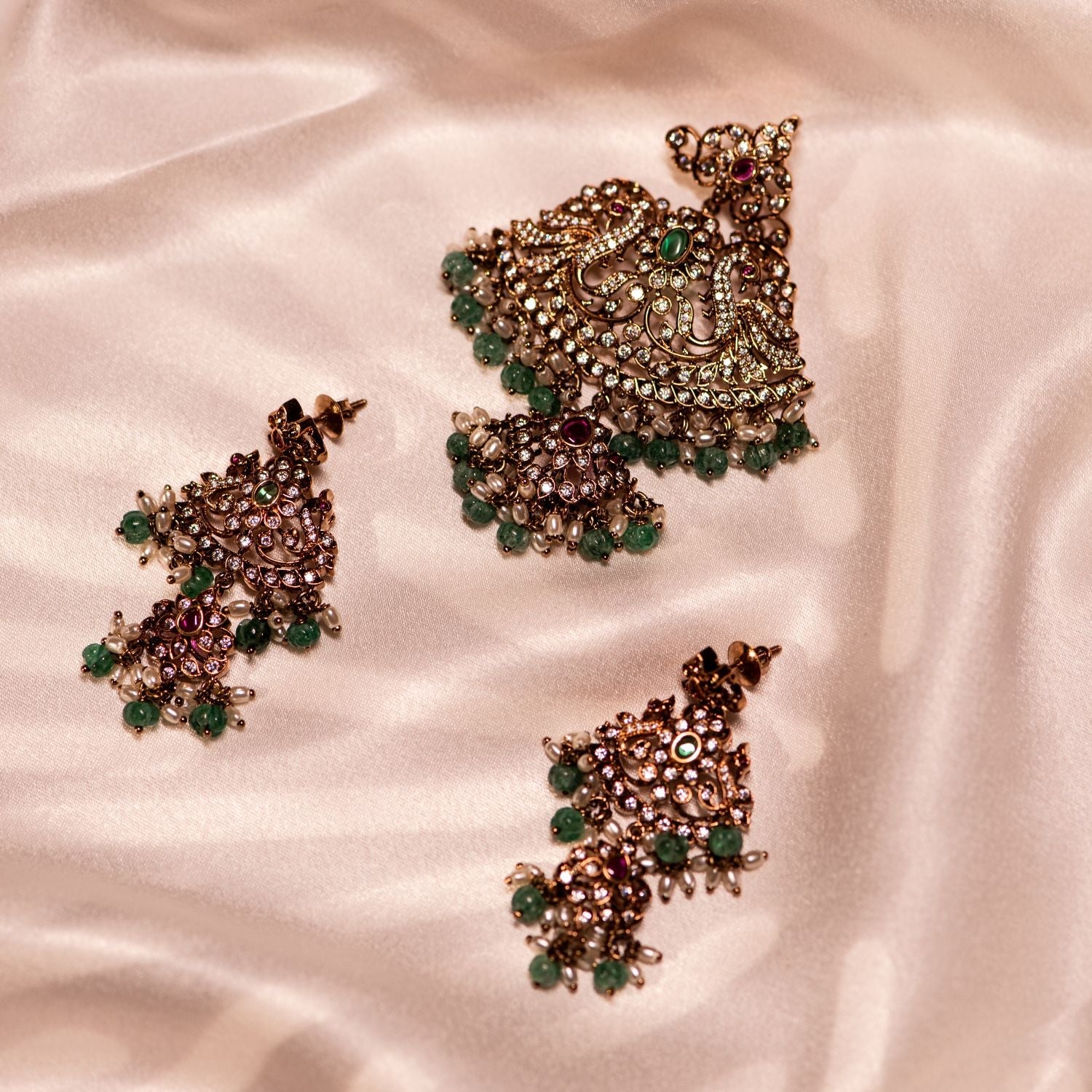 Gold-plated silver Pendant  adorned with Moissanite Polki stones, CZ stones, green cut stones, and red spinel stones, elegantly complemented by green beads and white pearls, creating a timeless and sophisticated look.