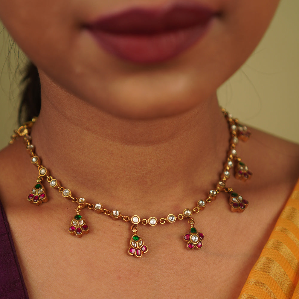 Jasmira Necklace: Graceful floral droplets adorned with red, white, and green kundans, set in gold-plated silver—timeless elegance redefined.