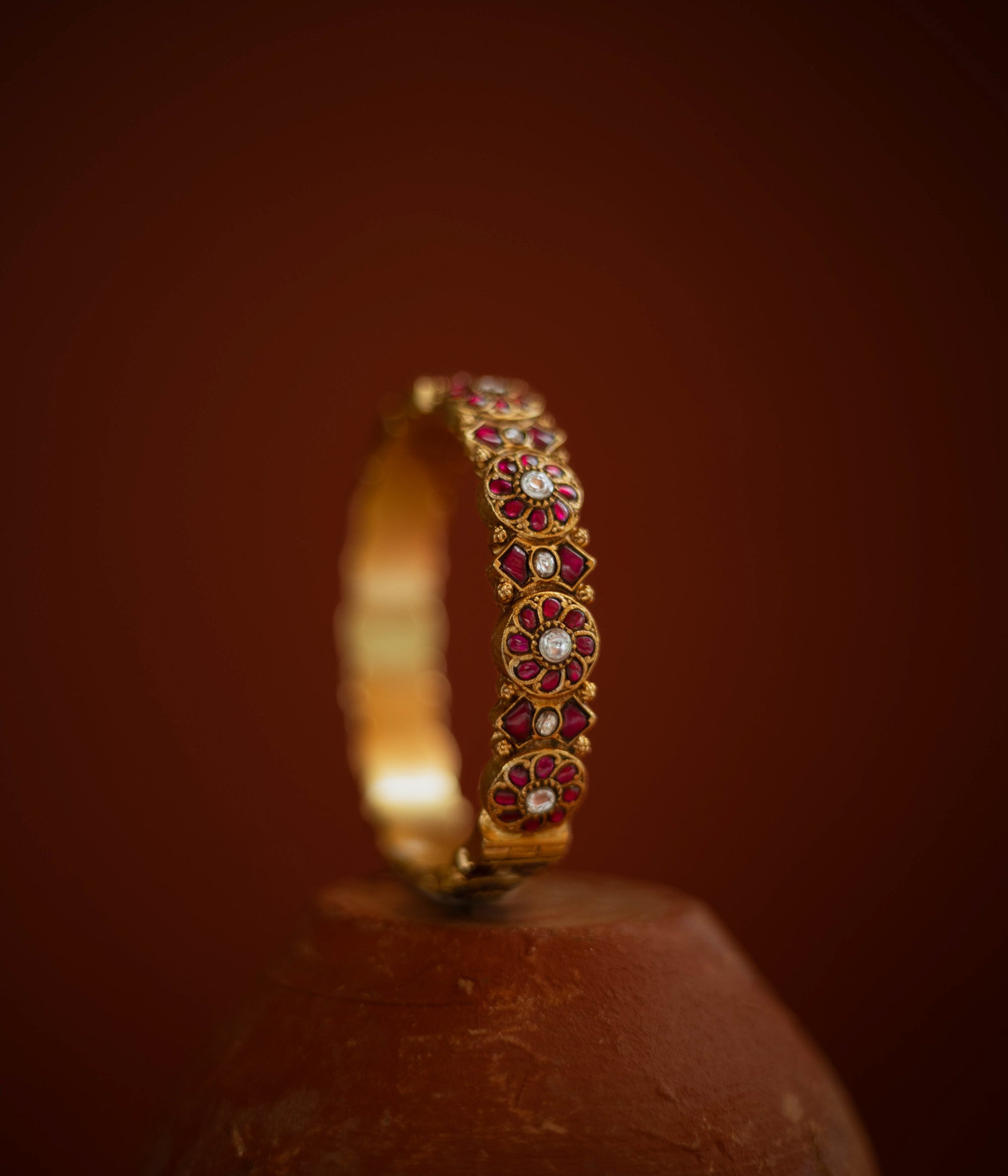 Gold bangle with red and white Kundan stones in floral pattern from Kundan collection.