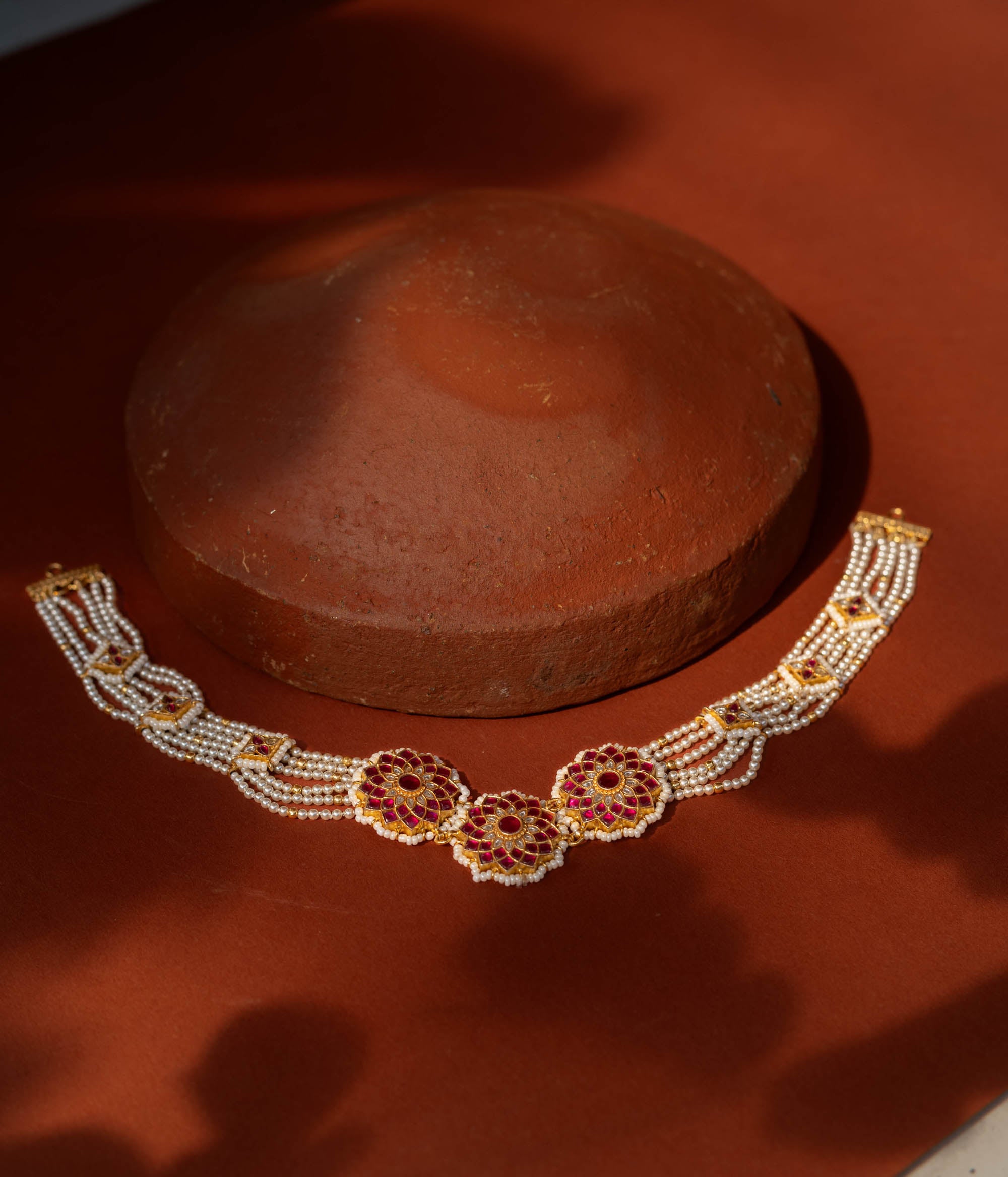 Elegant Ruby Bloom Pearl Choker in 92.5 Sterling Silver, featuring ruby-studded floral motifs and multiple strands of lustrous pearls with golden connectors.