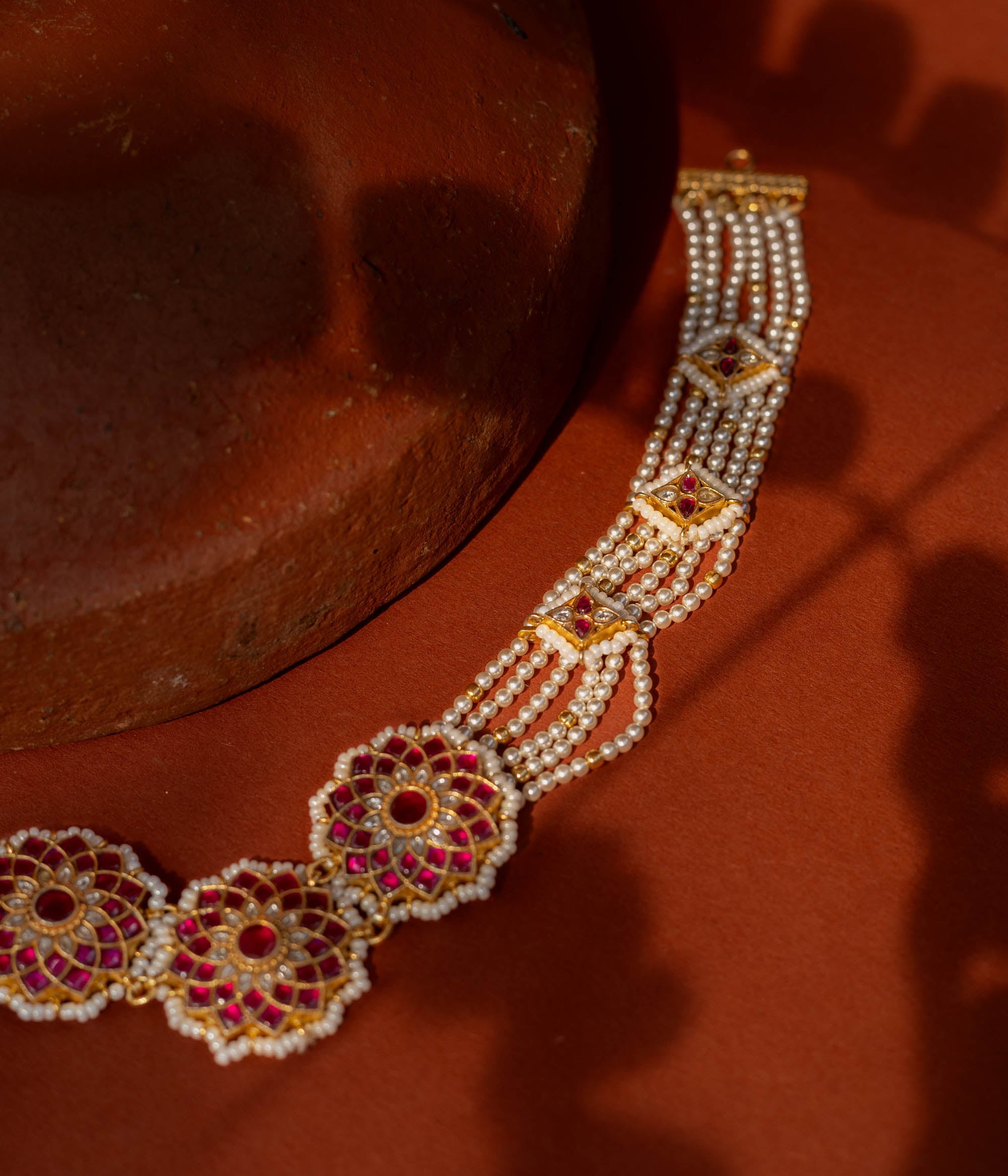 Elegant Ruby Bloom Pearl Choker in 92.5 Sterling Silver, featuring ruby-studded floral motifs and multiple strands of lustrous pearls with golden connectors.