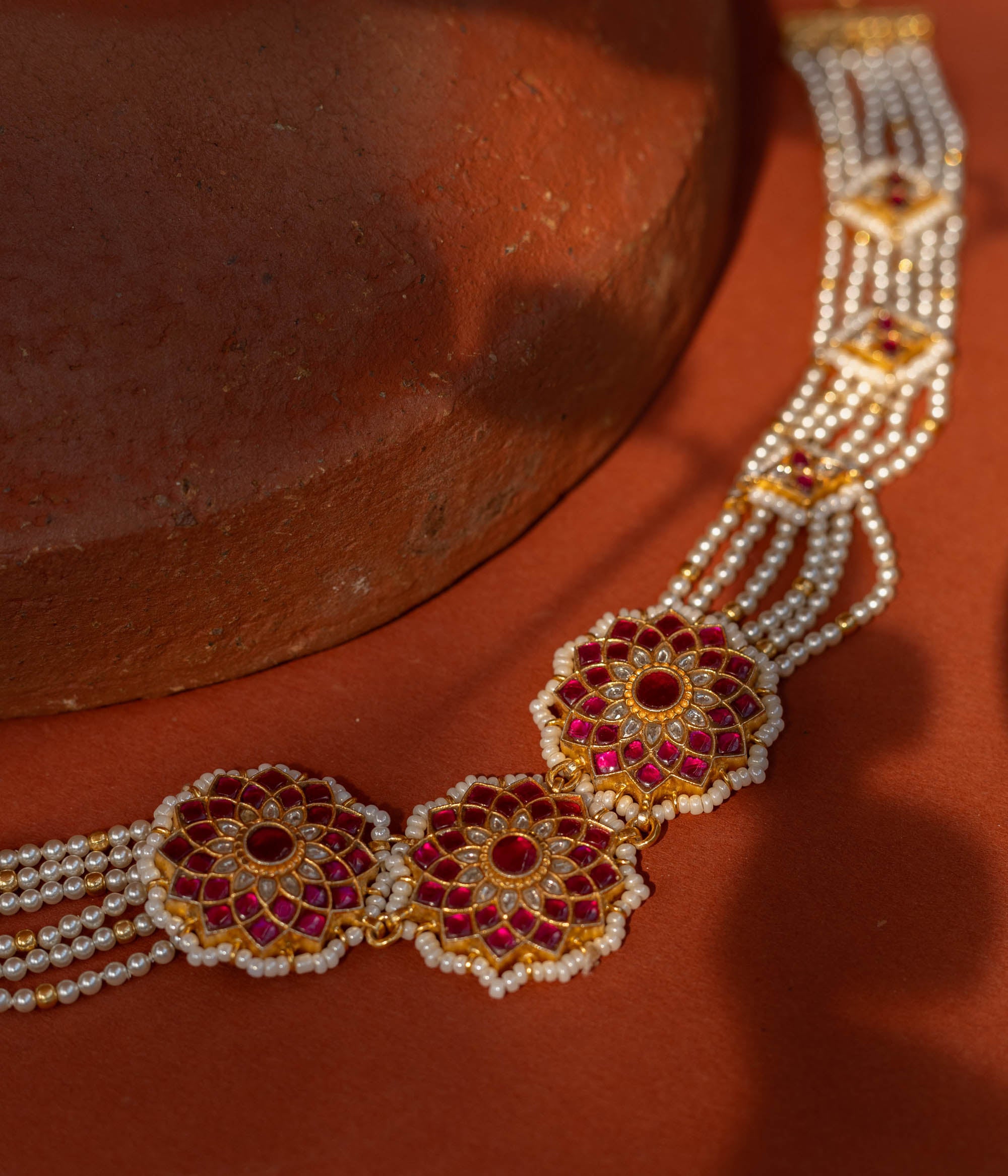 Elegant Ruby Bloom Pearl Choker in 92.5 Sterling Silver, featuring ruby-studded floral motifs and multiple strands of lustrous pearls with golden connectors.