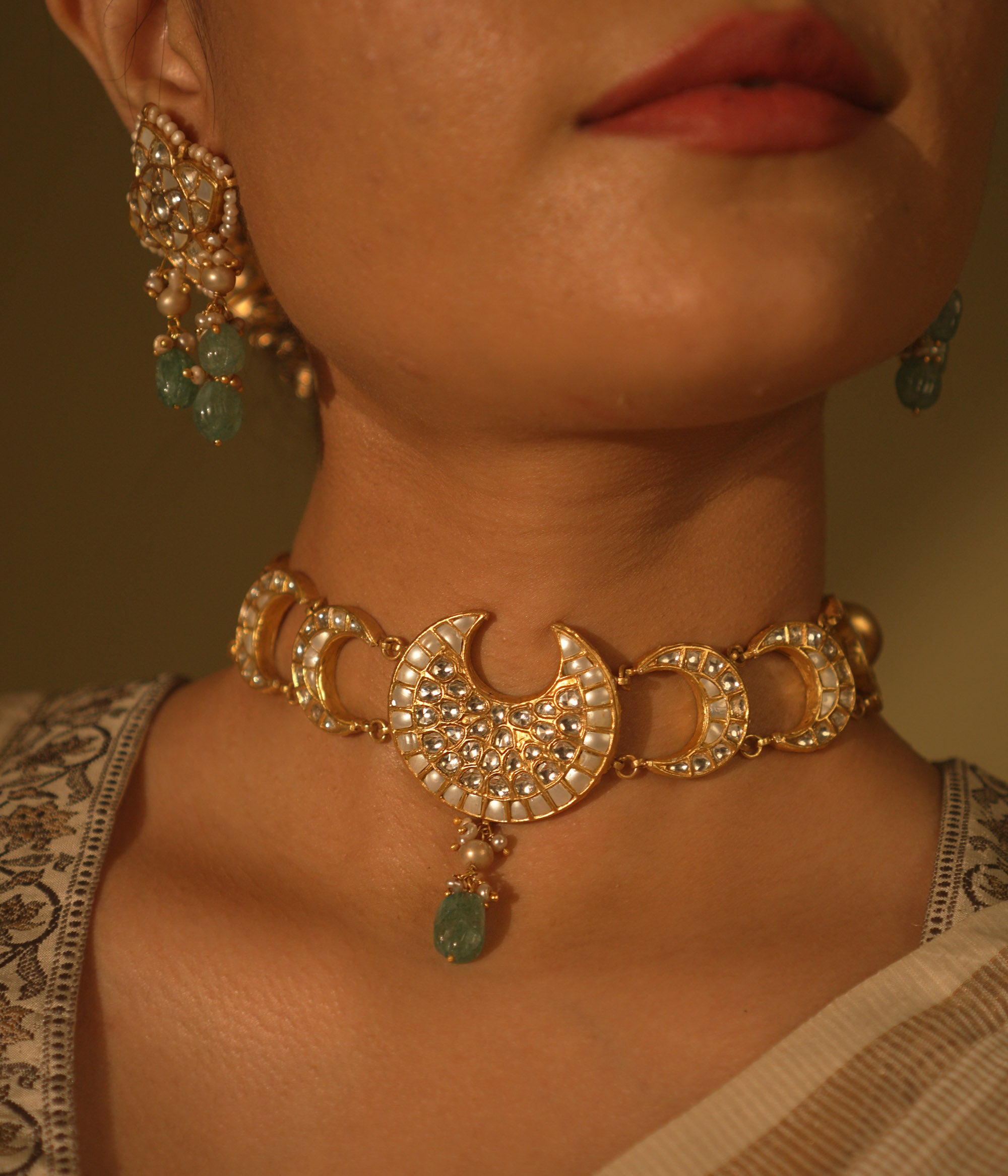 Celestial-themed choker with moon and star motifs, adorned with polkis and Kundan stones.