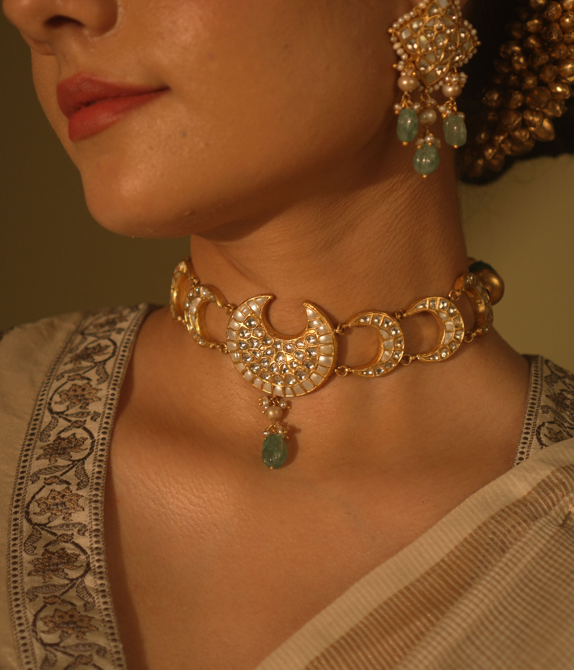 Celestial-themed choker with moon and star motifs, adorned with polkis and Kundan stones.