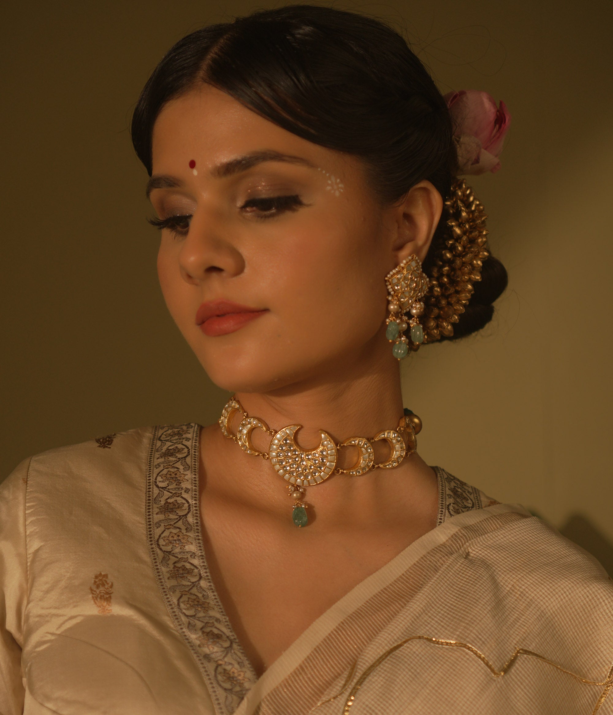 Celestial-themed choker with moon and star motifs, adorned with polkis and Kundan stones.