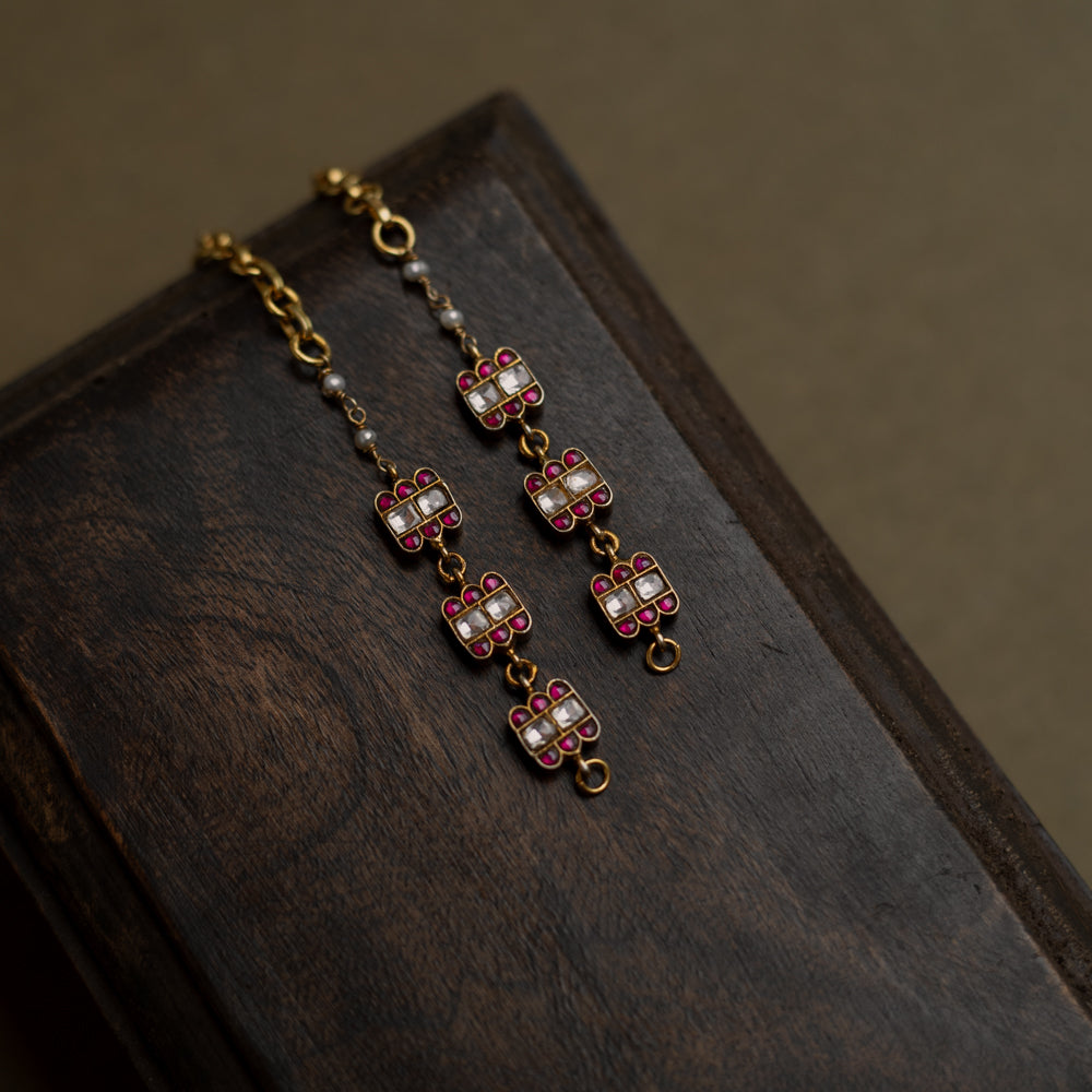 Kundan Collection ear chain with red kundan stones and white kundan highlights in flame-inspired motif.