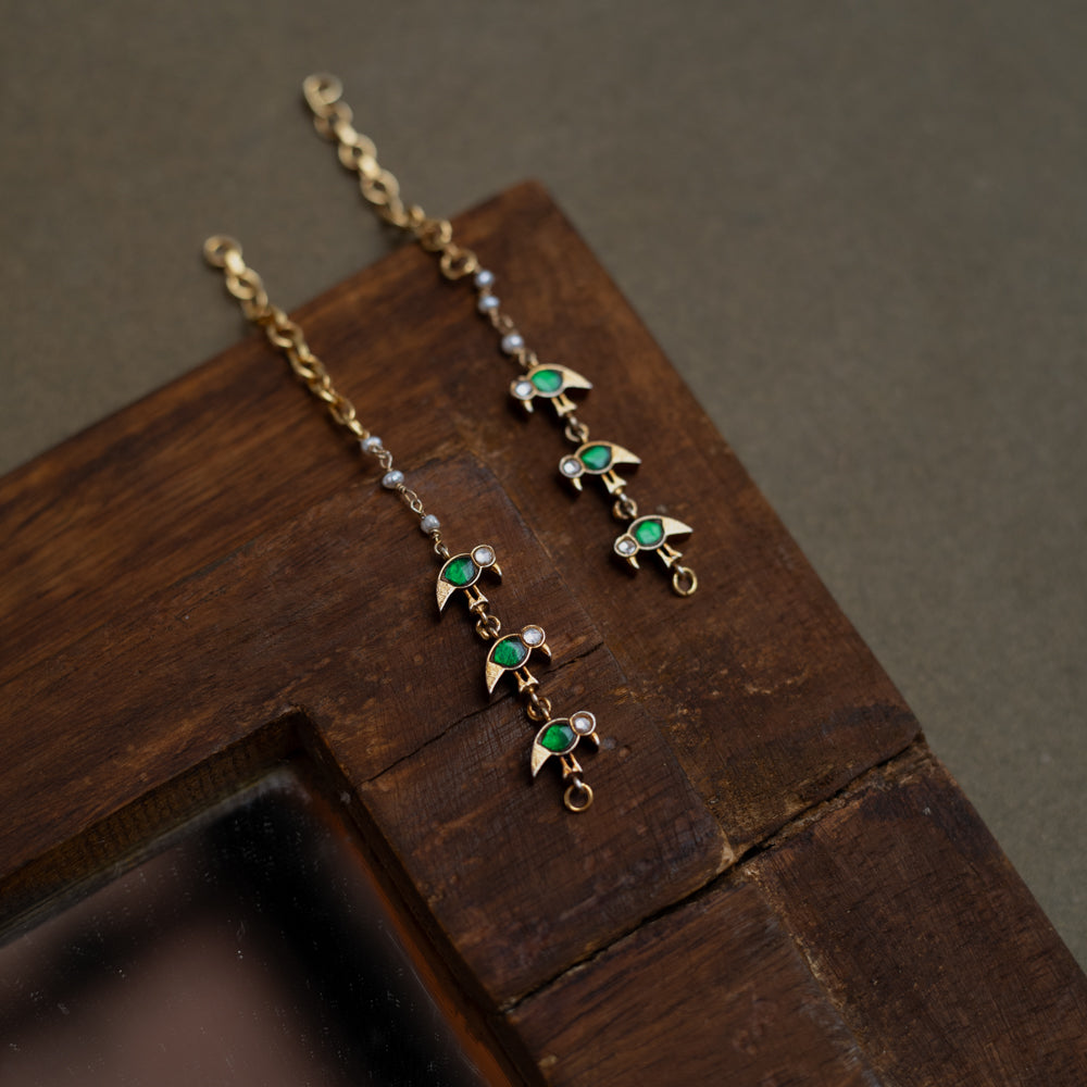 Kundan Collection ear chain with green kundan leaf motifs and white kundan accents in vine design.
